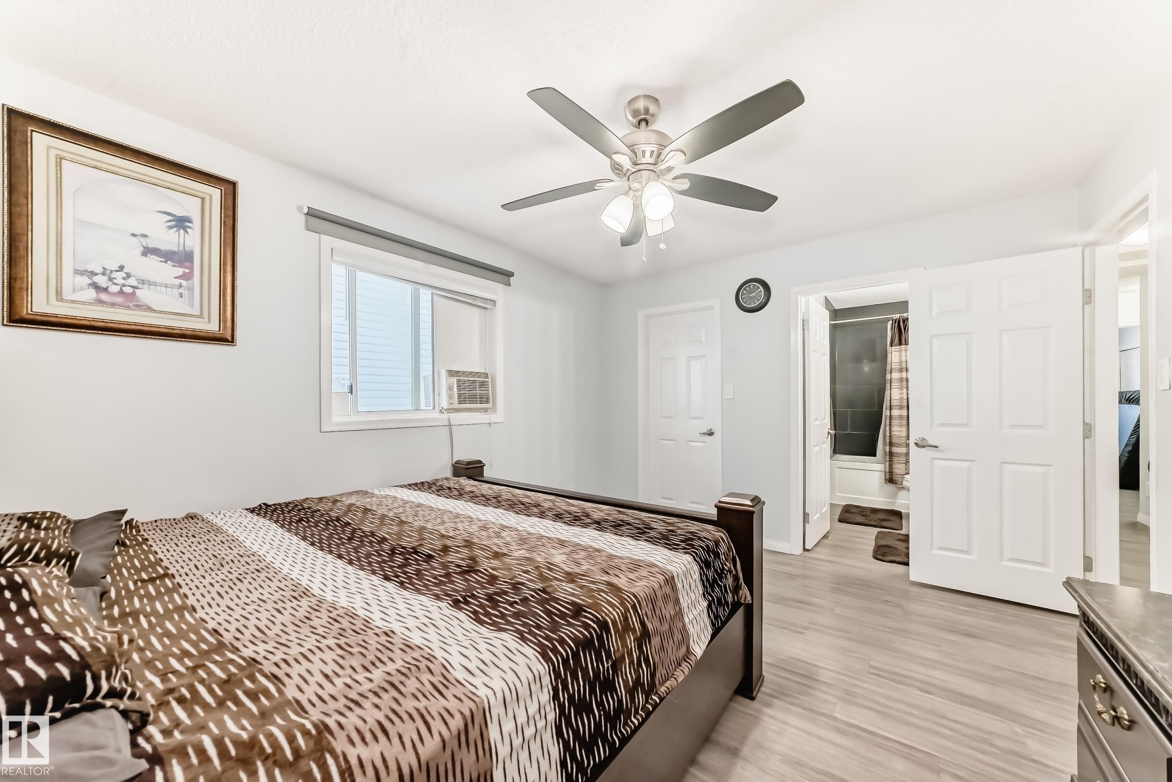 Bedroom featuring ensuite bathroom, light wood-type flooring, and ceiling fan - 6 Jefferson Road, Edmonton, AB - Indoor Photo Showing Bedroom