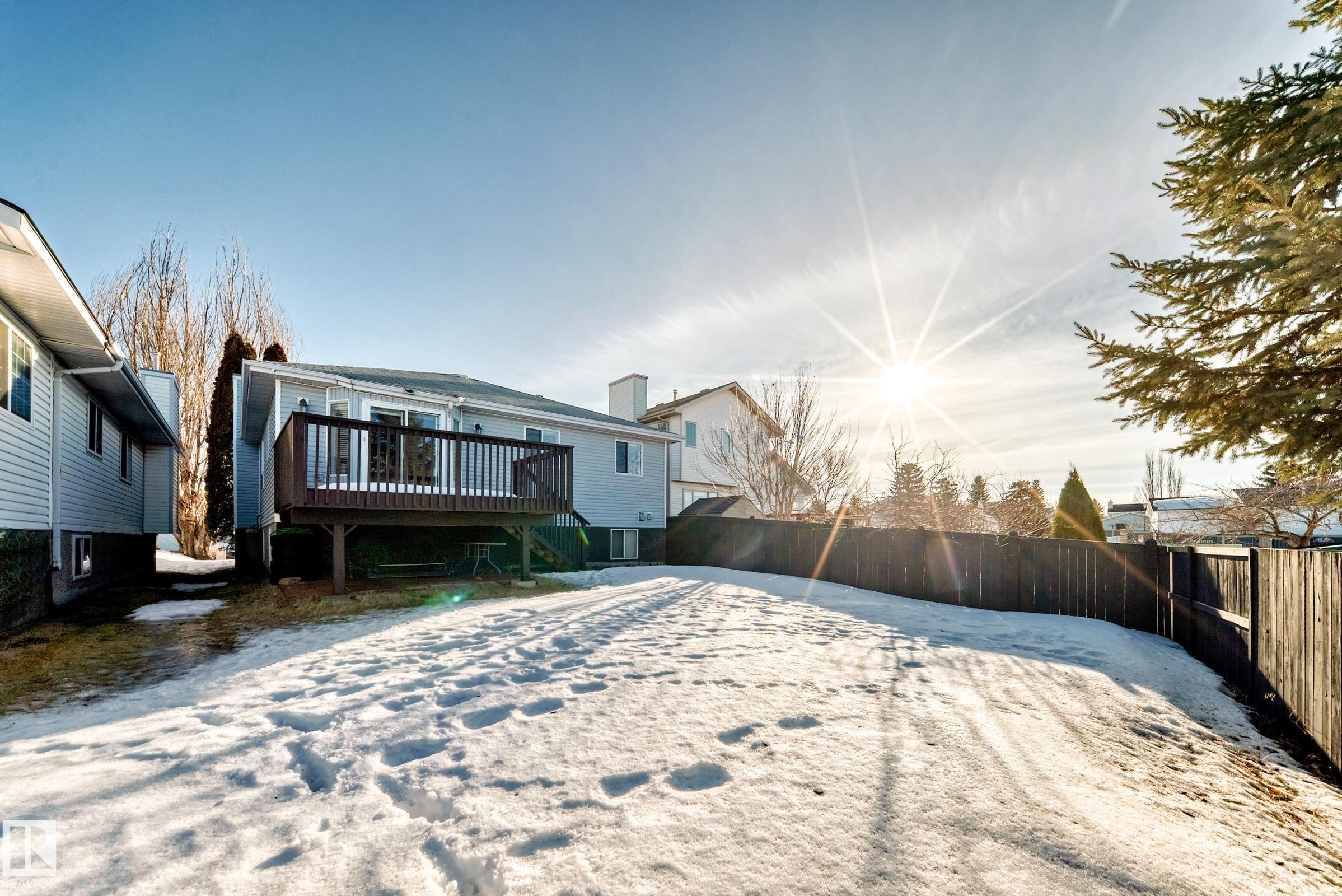 Snow covered property with a fenced backyard and a deck - 6 Jefferson Road, Edmonton, AB - Outdoor With Deck Patio Veranda