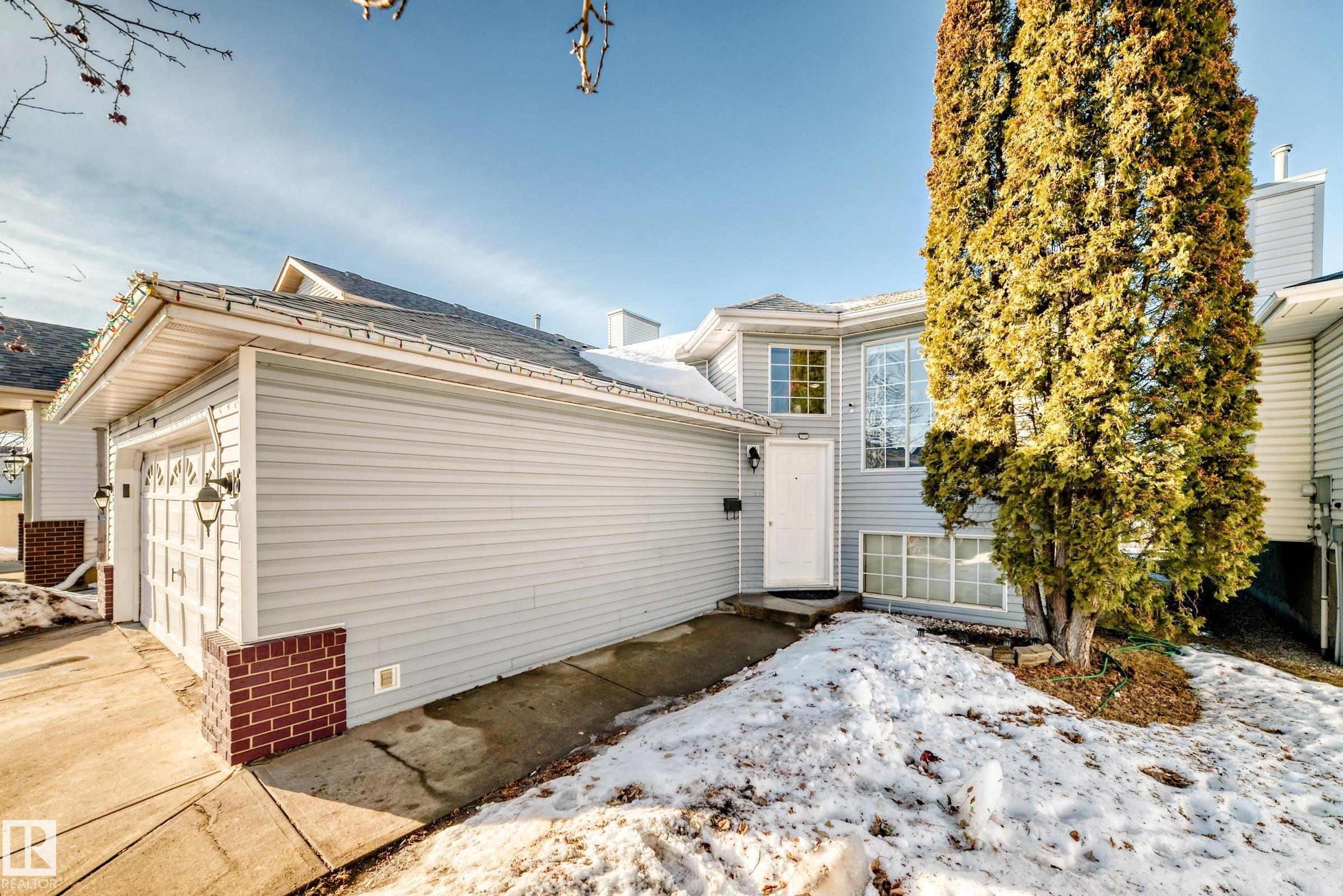 View of front of house featuring a garage, concrete driveway, and a shingled roof - 6 Jefferson Road, Edmonton, AB - Outdoor