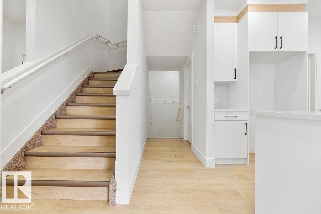 Staircase featuring wood finished floors - 235 Linden Loop, Leduc, AB - Indoor Photo Showing Other Room