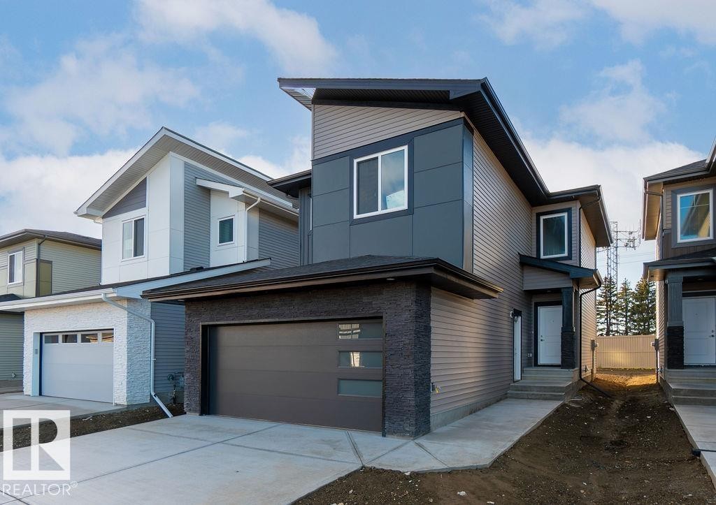 Contemporary house featuring concrete driveway and an attached garage - 235 Linden Loop, Leduc, AB - Outdoor