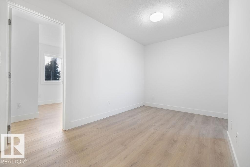 Empty room with light wood-type flooring and a textured ceiling - 235 Linden Loop, Leduc, AB - Indoor Photo Showing Other Room