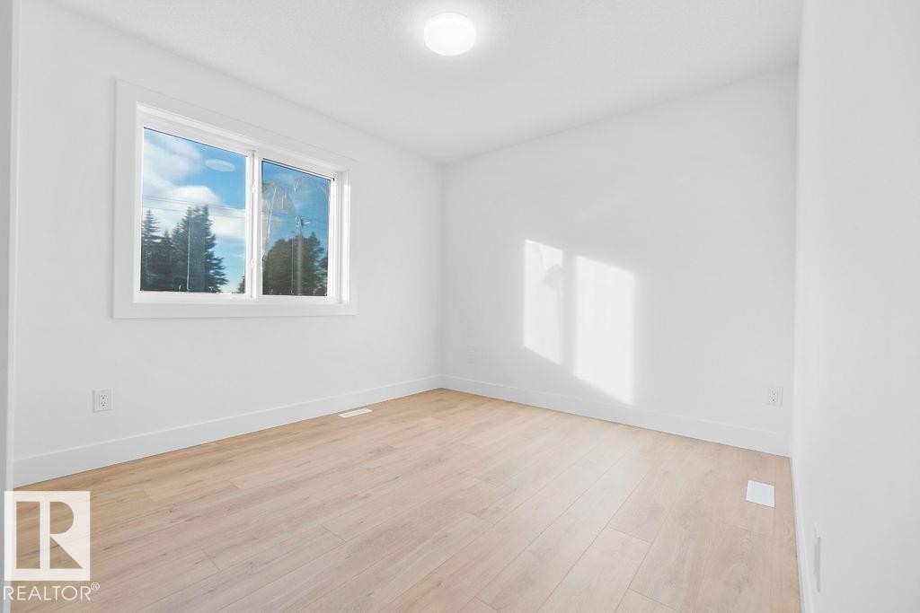 Empty room with baseboards and light wood finished floors - 235 Linden Loop, Leduc, AB - Indoor Photo Showing Other Room