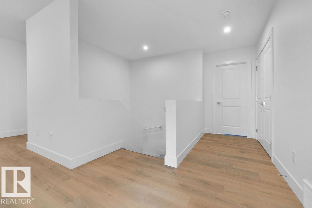 Hallway featuring an upstairs landing, light wood-style floors, and recessed lighting - 235 Linden Loop, Leduc, AB - Indoor Photo Showing Other Room