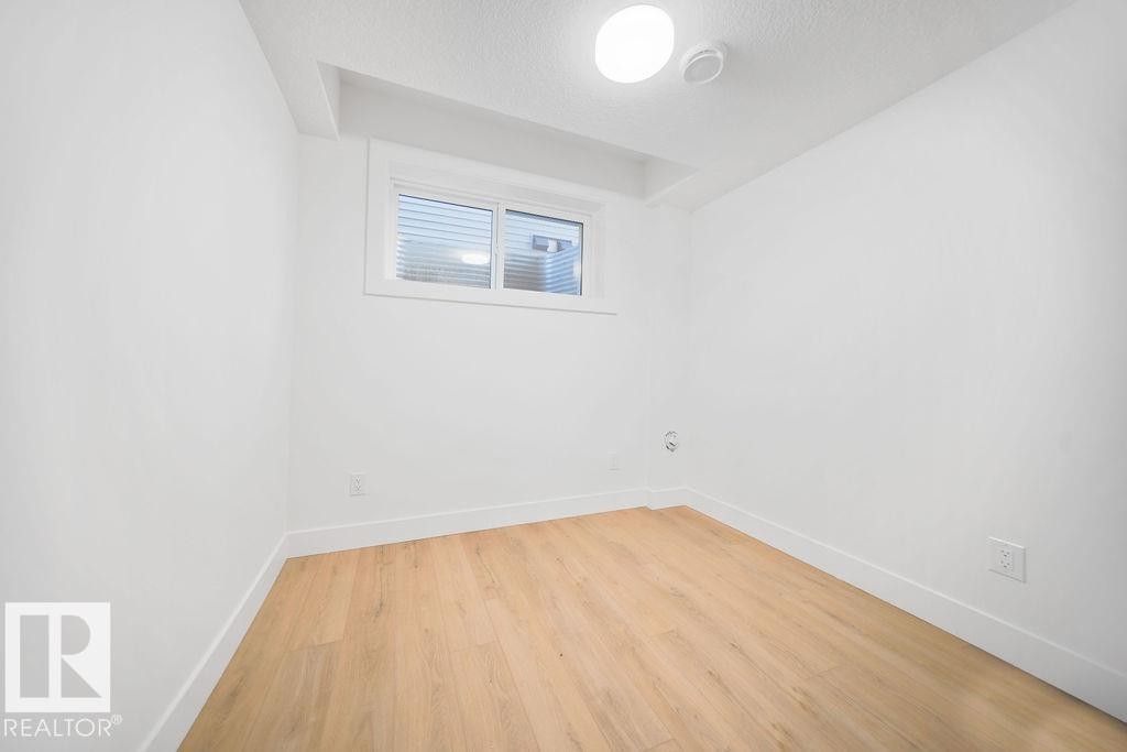 Empty room with light wood-style flooring and a textured ceiling - 235 Linden Loop, Leduc, AB - Indoor Photo Showing Other Room