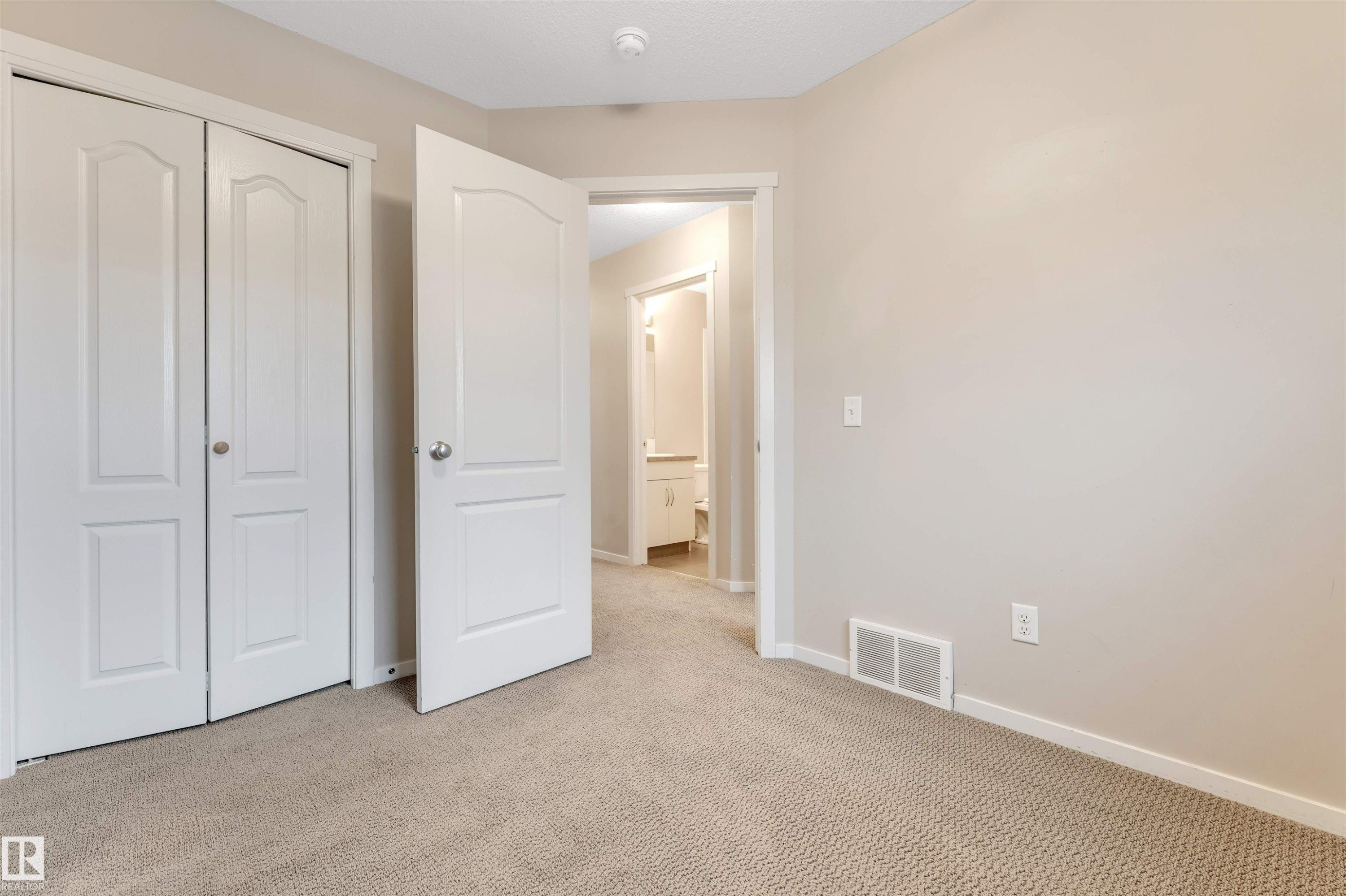 Unfurnished bedroom featuring a closet and carpet floors - 610 Tamarack Road, Edmonton, AB - Indoor Photo Showing Other Room