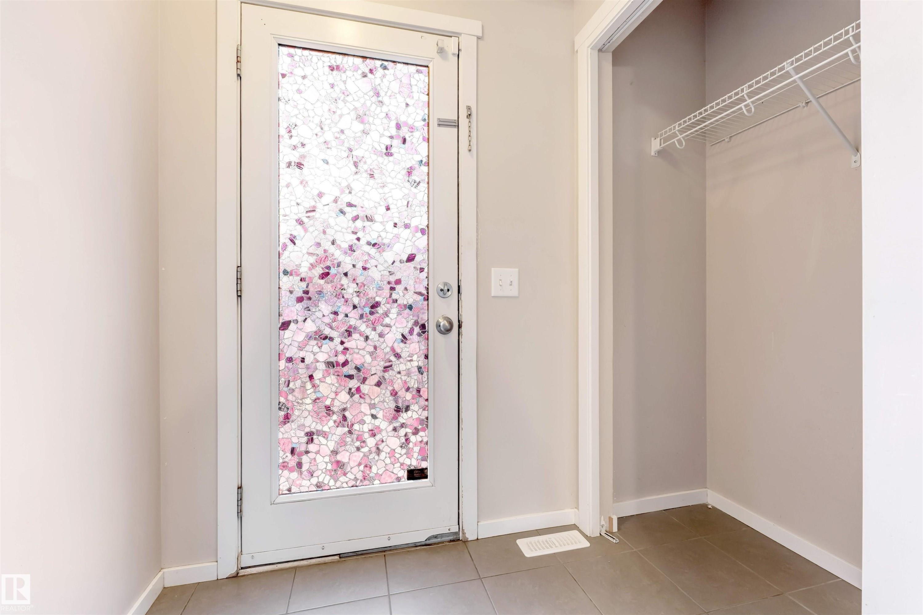 Doorway to outside with baseboards and tile patterned floors - 610 Tamarack Road, Edmonton, AB - Indoor Photo Showing Other Room