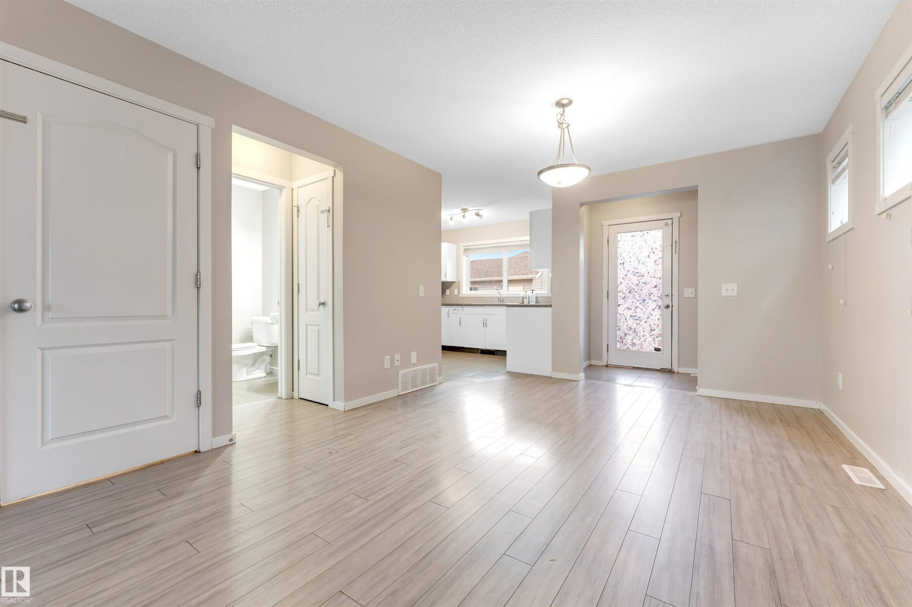 Entrance foyer featuring light wood-type flooring and baseboards - 610 Tamarack Road, Edmonton, AB - Indoor Photo Showing Other Room