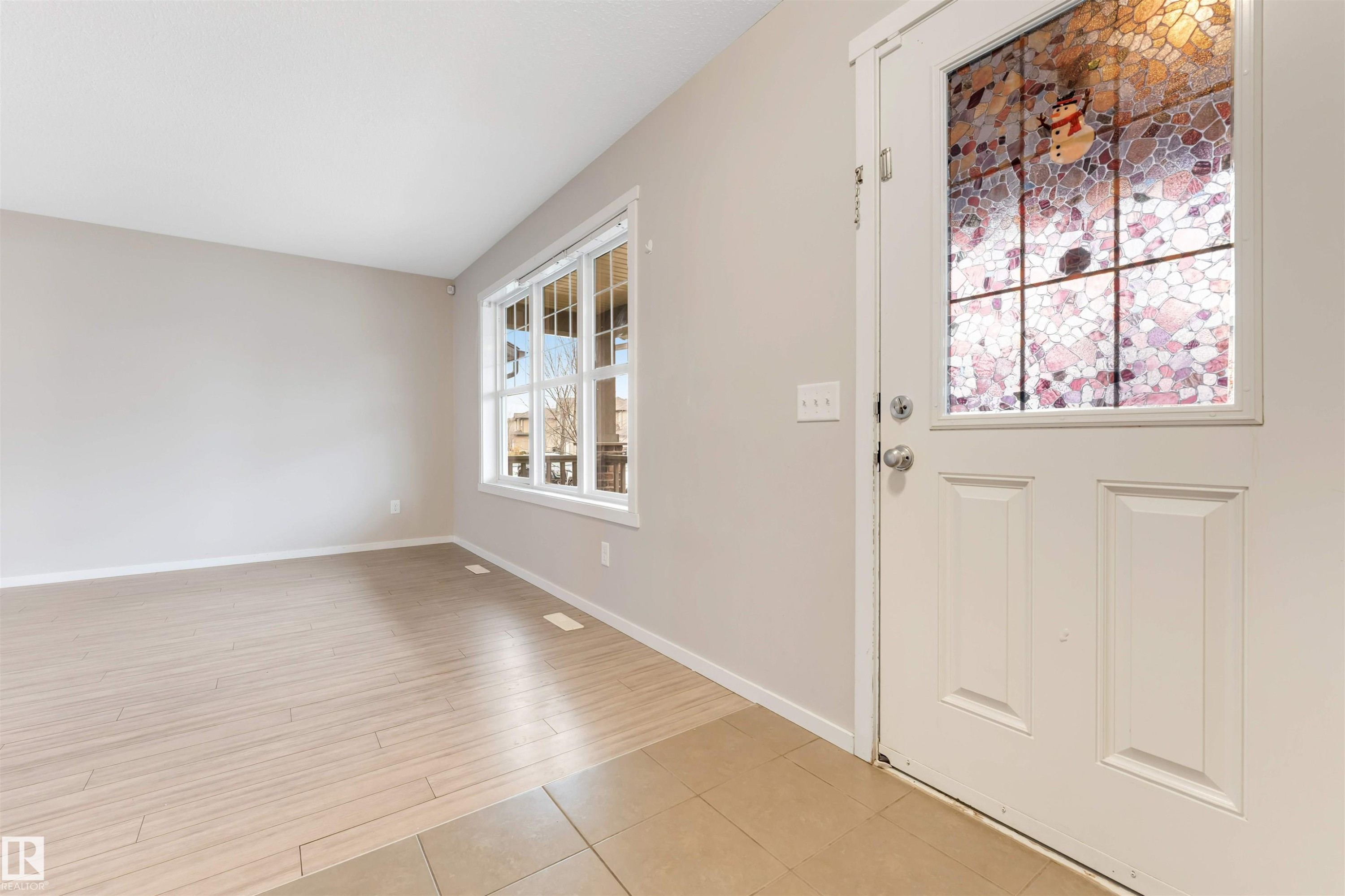 Entrance foyer with baseboards and light tile patterned flooring - 610 Tamarack Road, Edmonton, AB - Indoor Photo Showing Other Room
