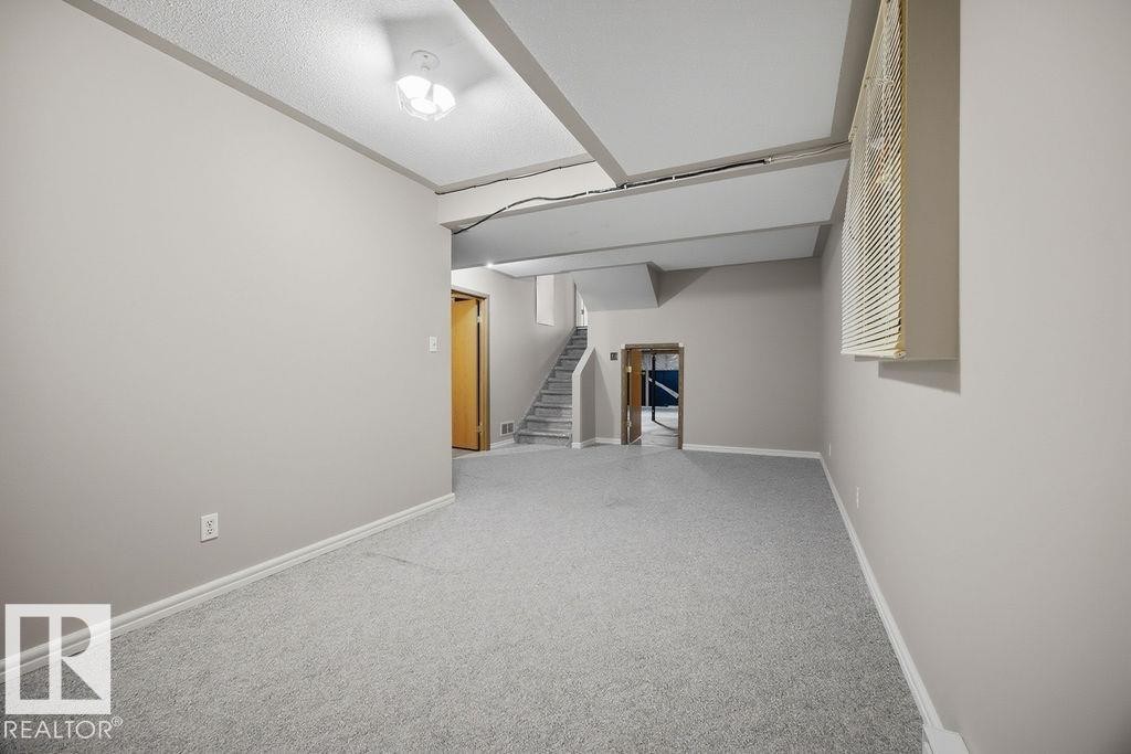 Finished basement with light colored carpet and baseboards - 736 Johns Road, Edmonton, AB - Indoor Photo Showing Other Room