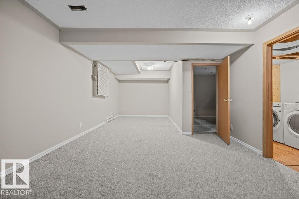 Finished below grade area featuring carpet floors and washer and dryer - 736 Johns Road, Edmonton, AB - Indoor Photo Showing Laundry Room