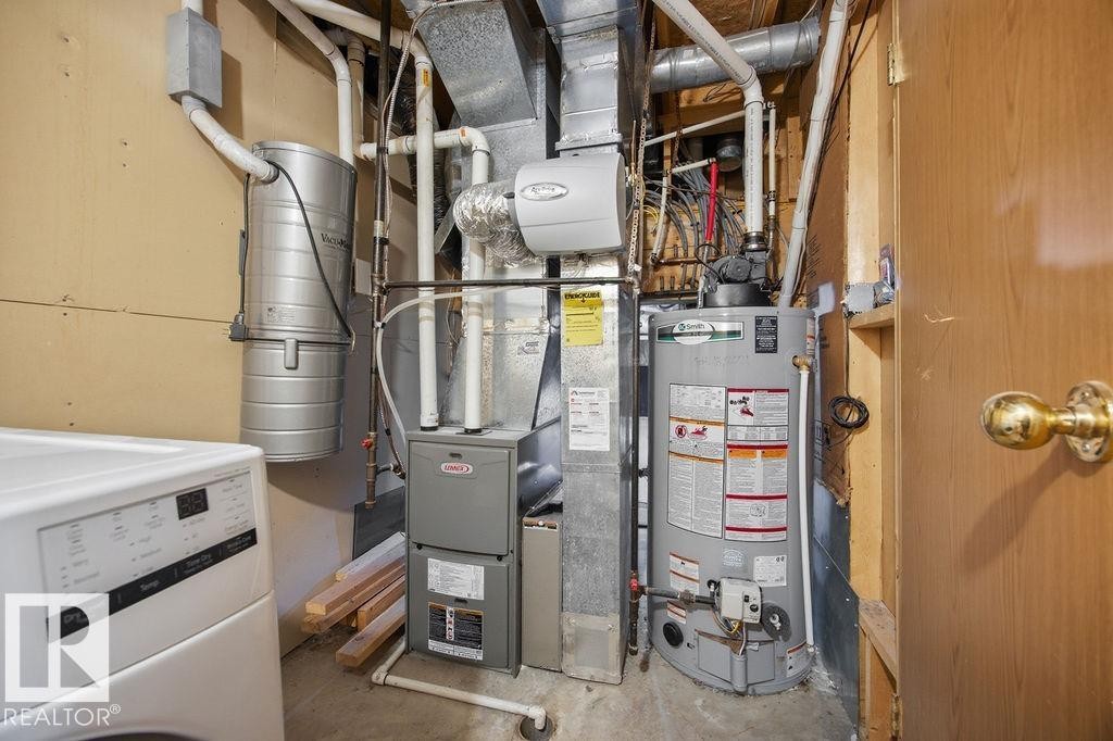 Utility room featuring washer / dryer, heating unit, and gas water heater - 736 Johns Road, Edmonton, AB - Indoor Photo Showing Basement