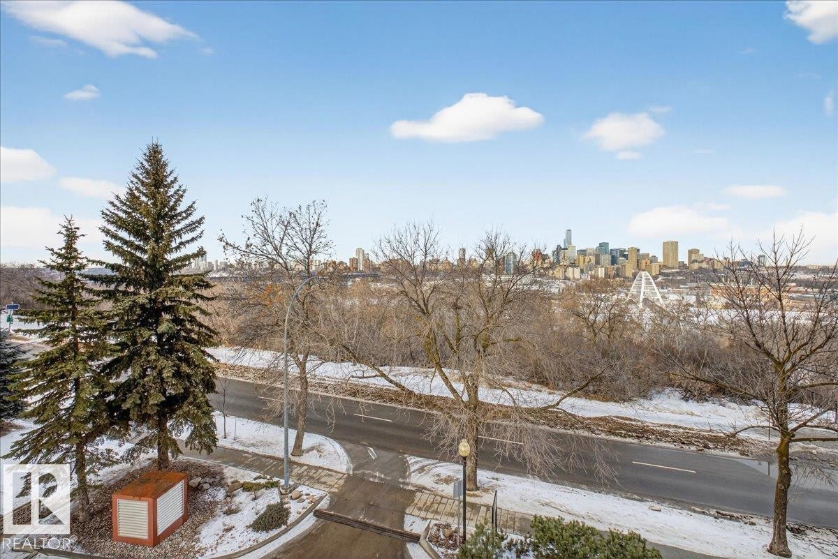 Yard layered in snow featuring a skyline view - 402 10649 Saskatchewan Drive, Edmonton, AB - Outdoor With View