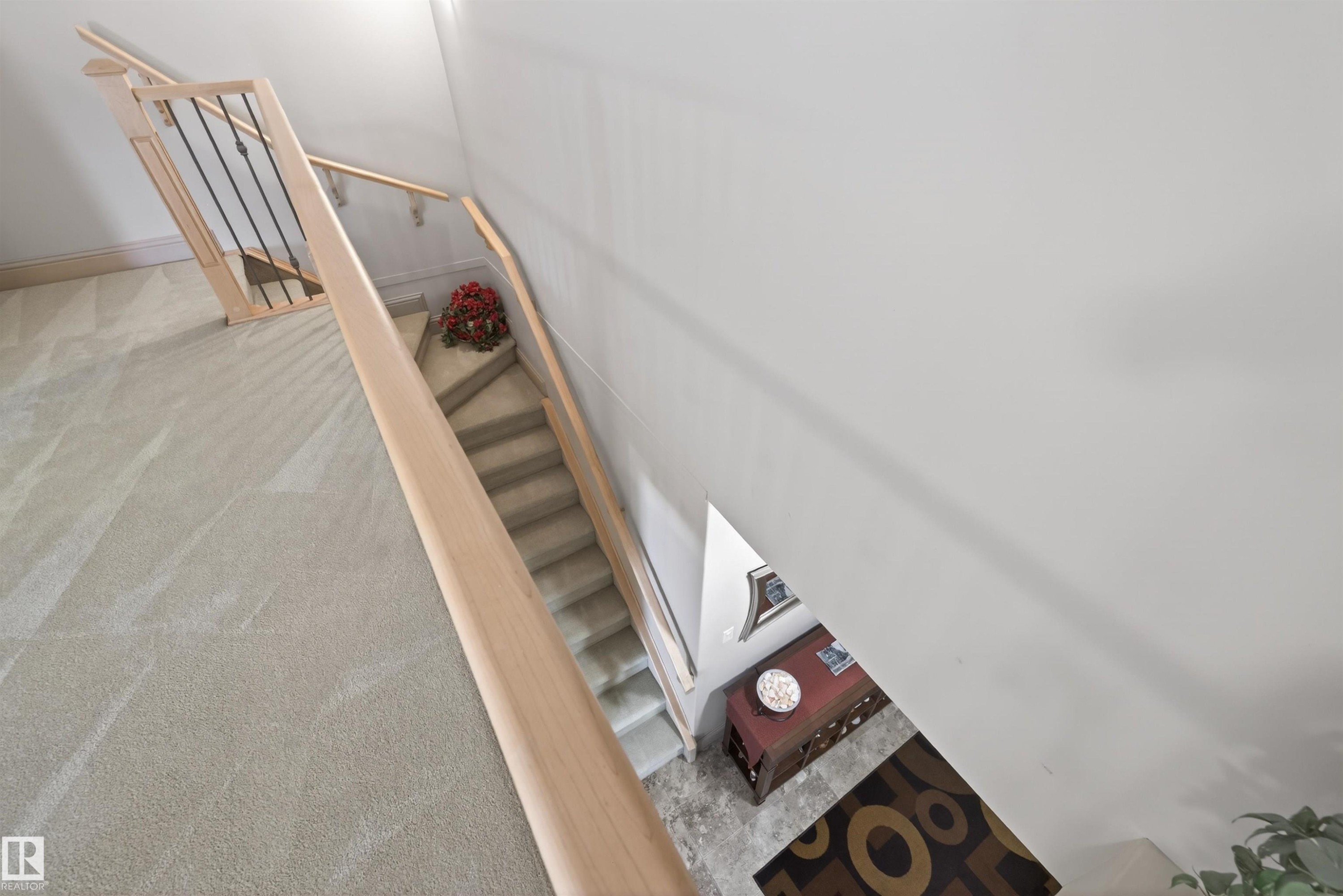 Staircase featuring carpet floors - 427 13005 140 Avenue, Edmonton, AB - Indoor Photo Showing Other Room