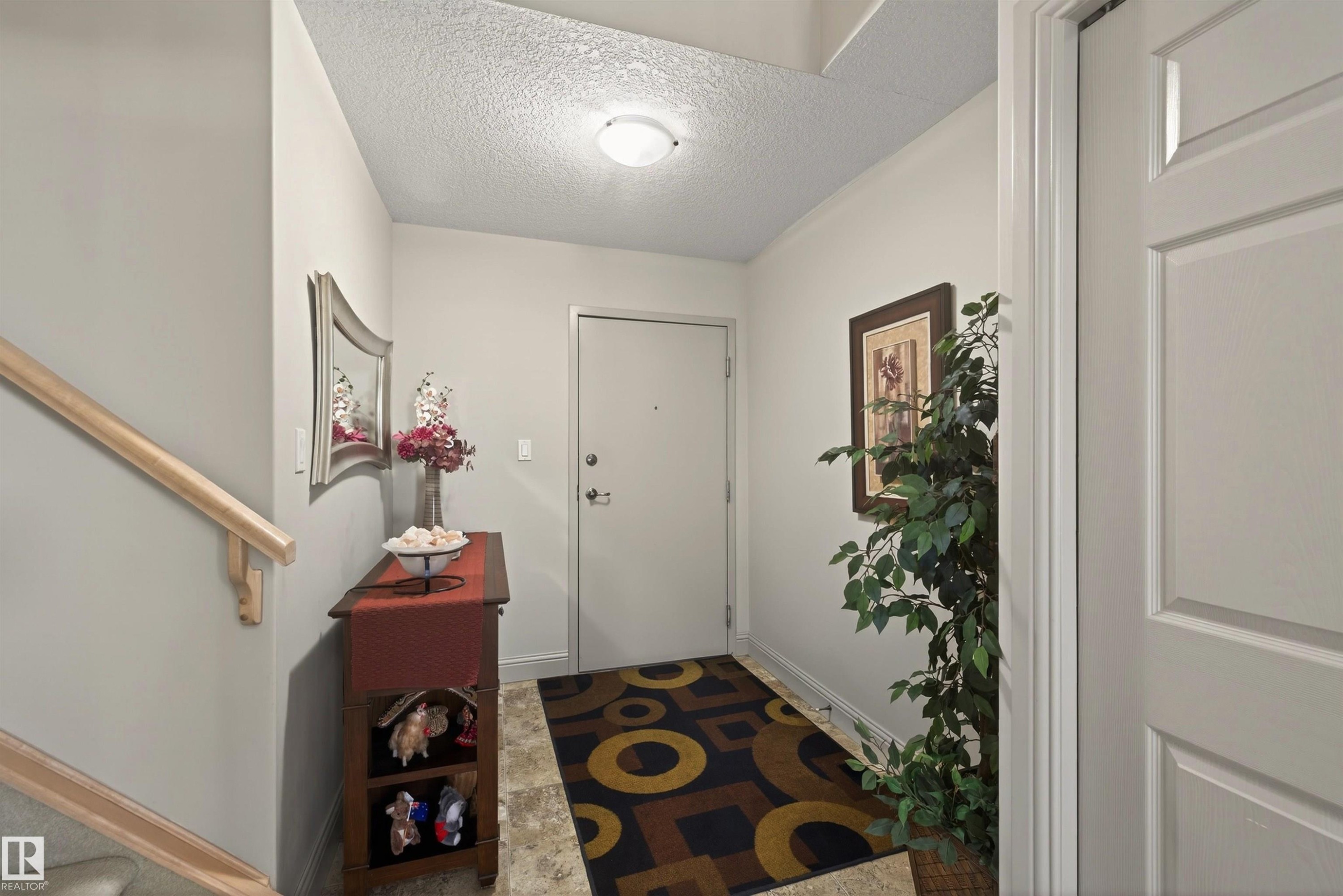 Large entry providing ample room to welcome guests with room for a bench and large front closet. - 427 13005 140 Avenue, Edmonton, AB - Indoor Photo Showing Other Room