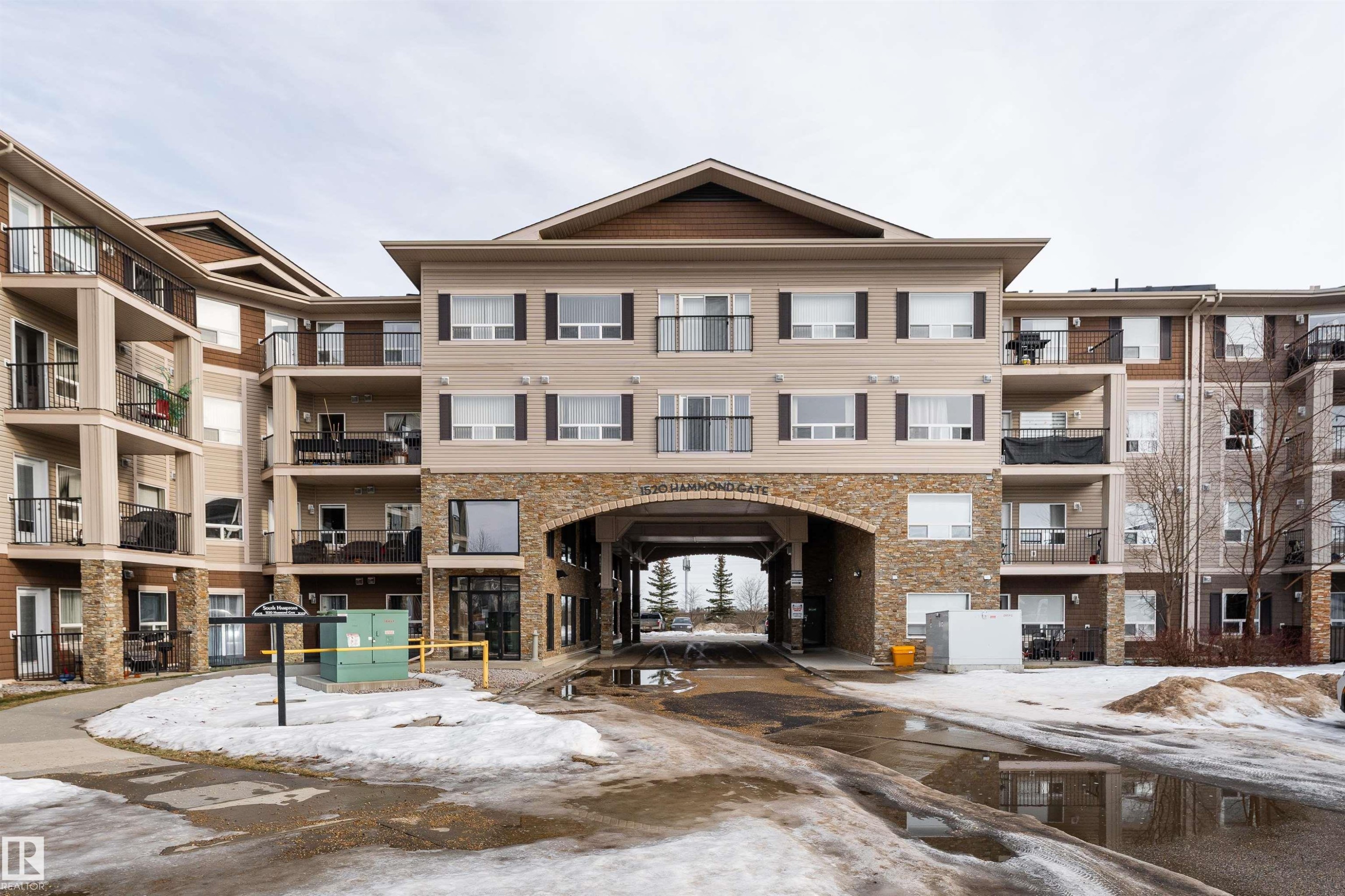 Snow covered building with a view of apartment building / complex - 325 1520 Hammond Gate, Edmonton, AB - Outdoor With Balcony With Facade