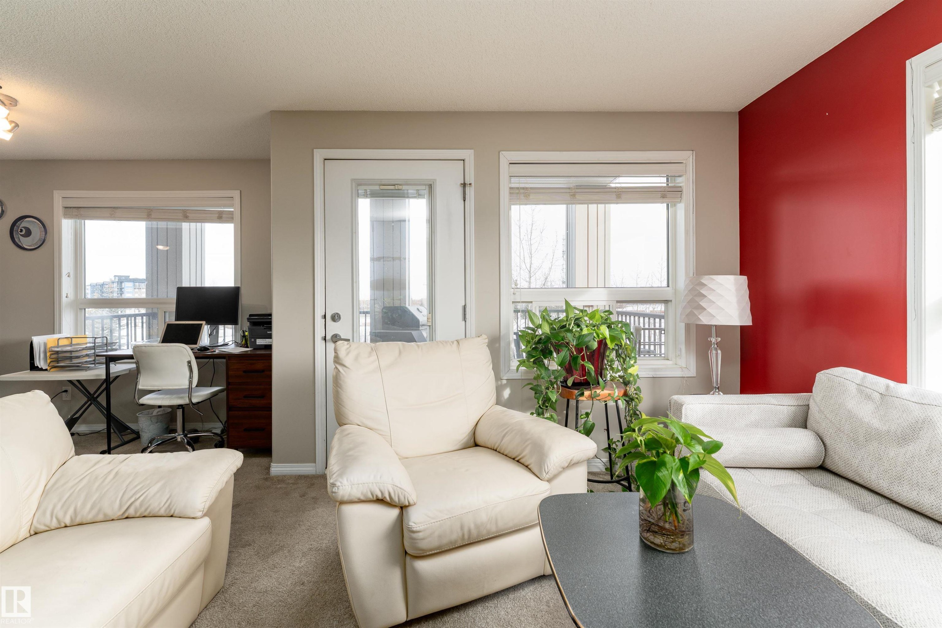 Carpeted living area featuring an office area - 325 1520 Hammond Gate, Edmonton, AB - Indoor Photo Showing Living Room