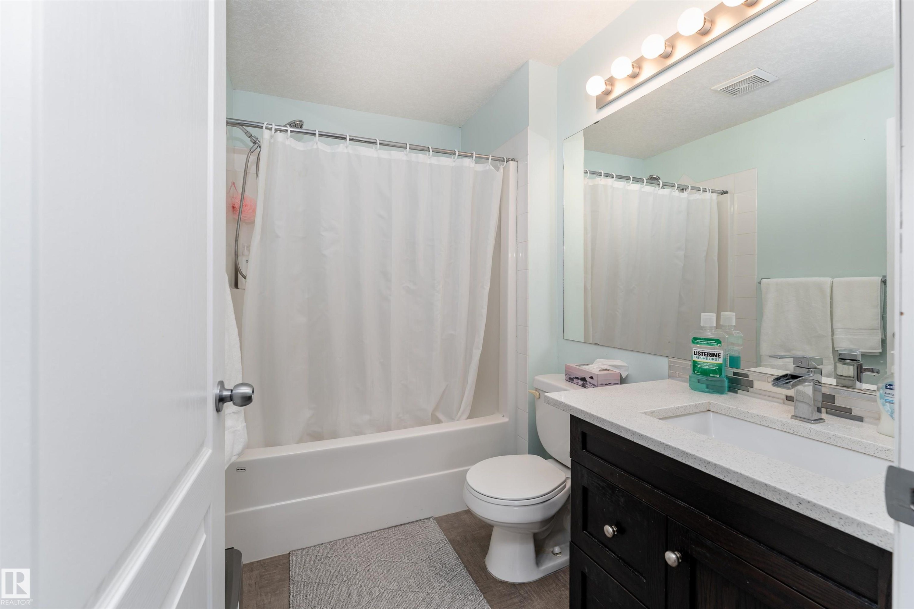 Bathroom featuring vanity and shower / bath combo - 325 1520 Hammond Gate, Edmonton, AB - Indoor Photo Showing Bathroom