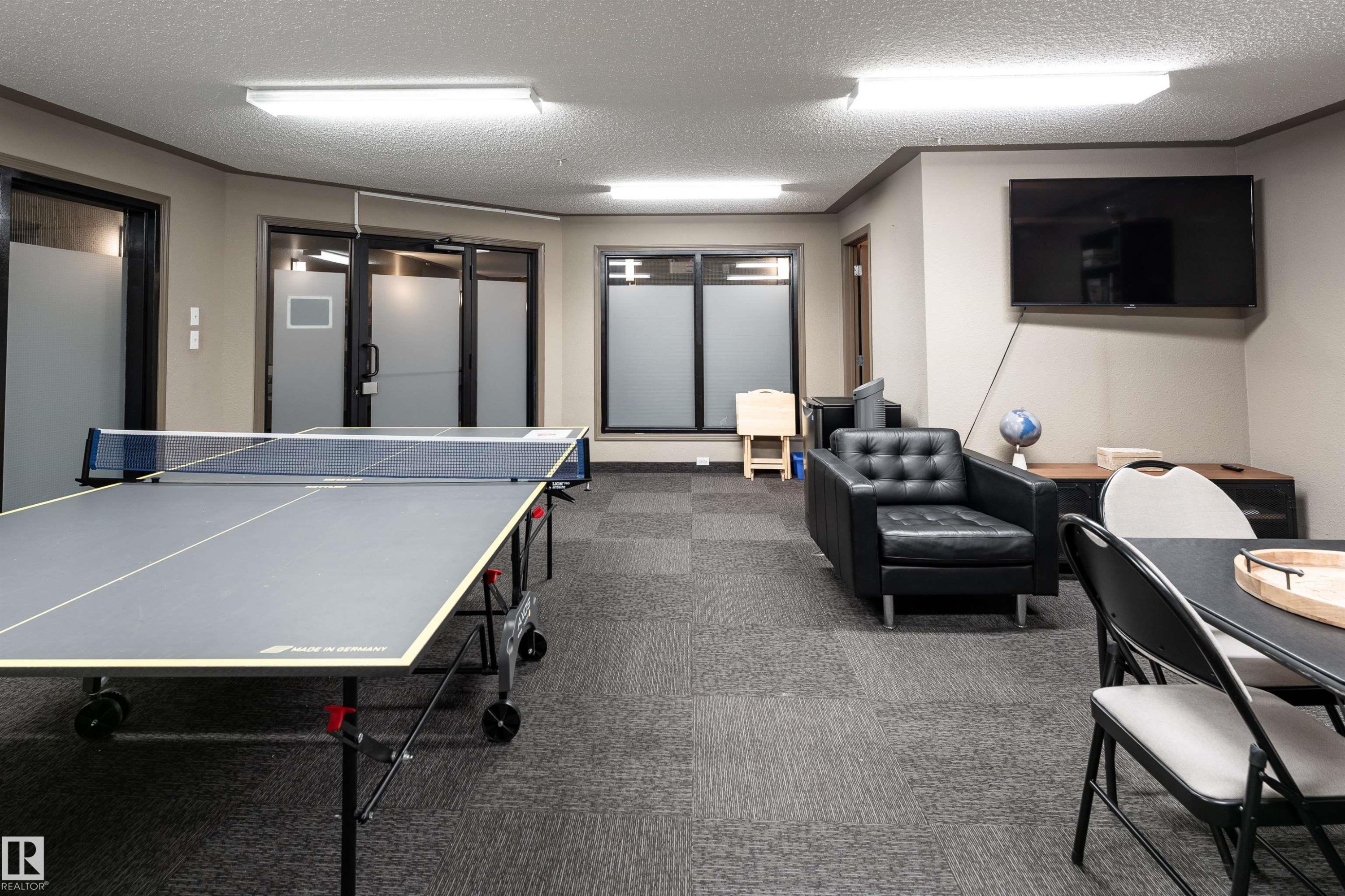 Game room with a textured ceiling and ornamental molding - 325 1520 Hammond Gate, Edmonton, AB - Indoor