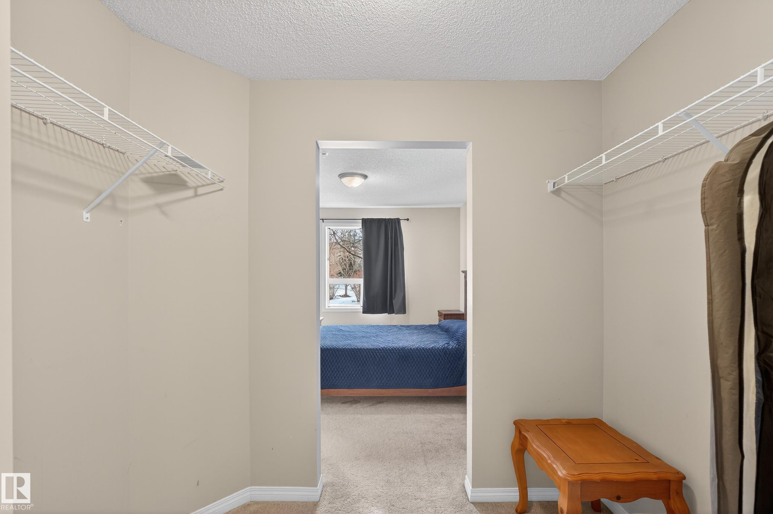 Walk in closet featuring light carpet - 131 1520 Hammond Gate, Edmonton, AB - Indoor With Storage