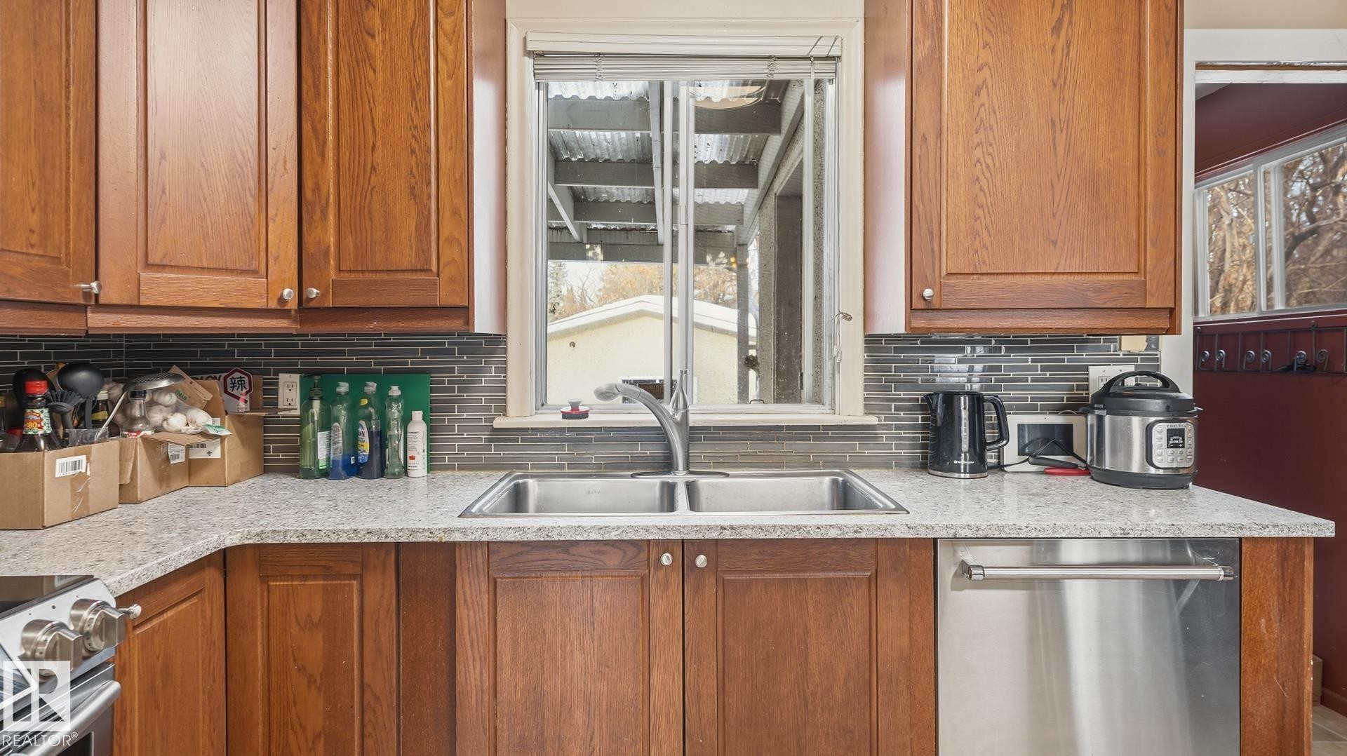 Kitchen with stainless steel appliances, wood finish cabinets, light stone countertops, and tasteful backsplash - 11520 78 Avenue Nw, Edmonton, AB - Indoor Photo Showing Kitchen With Double Sink