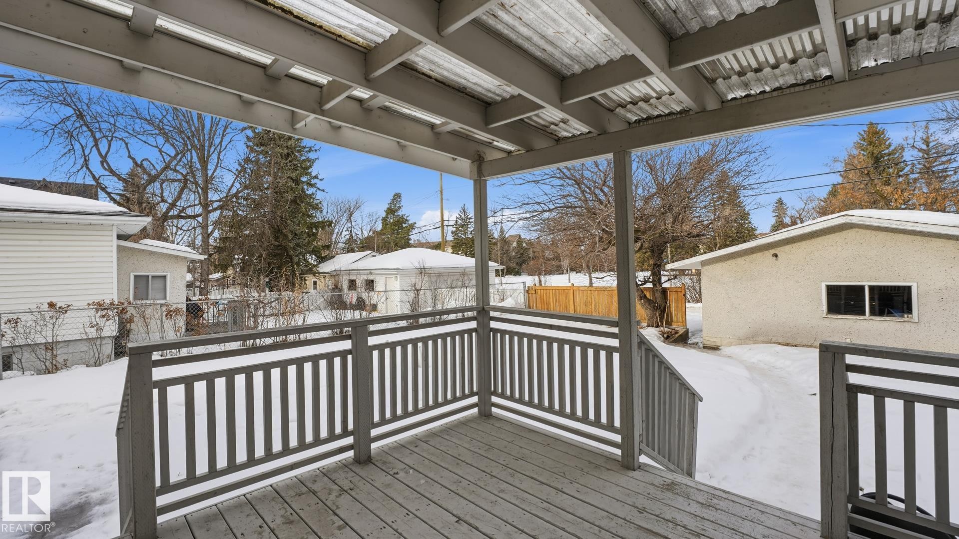 Snow covered deck with a fenced backyard - 11520 78 Avenue Nw, Edmonton, AB - Outdoor With Exterior