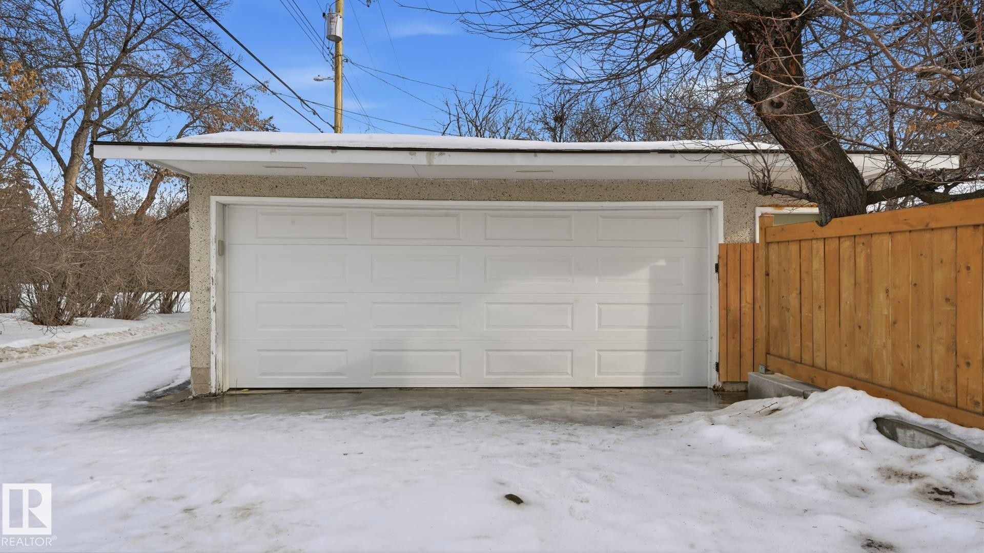 Snow covered garage with a detached garage - 11520 78 Avenue Nw, Edmonton, AB - Outdoor With Exterior