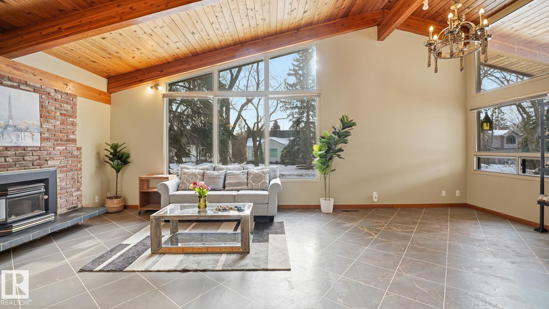 Living room featuring a high wood beamed ceiling, a chandelier, and a fireplace - 11520 78 Avenue Nw, Edmonton, AB - Indoor Photo Showing Living Room With Fireplace