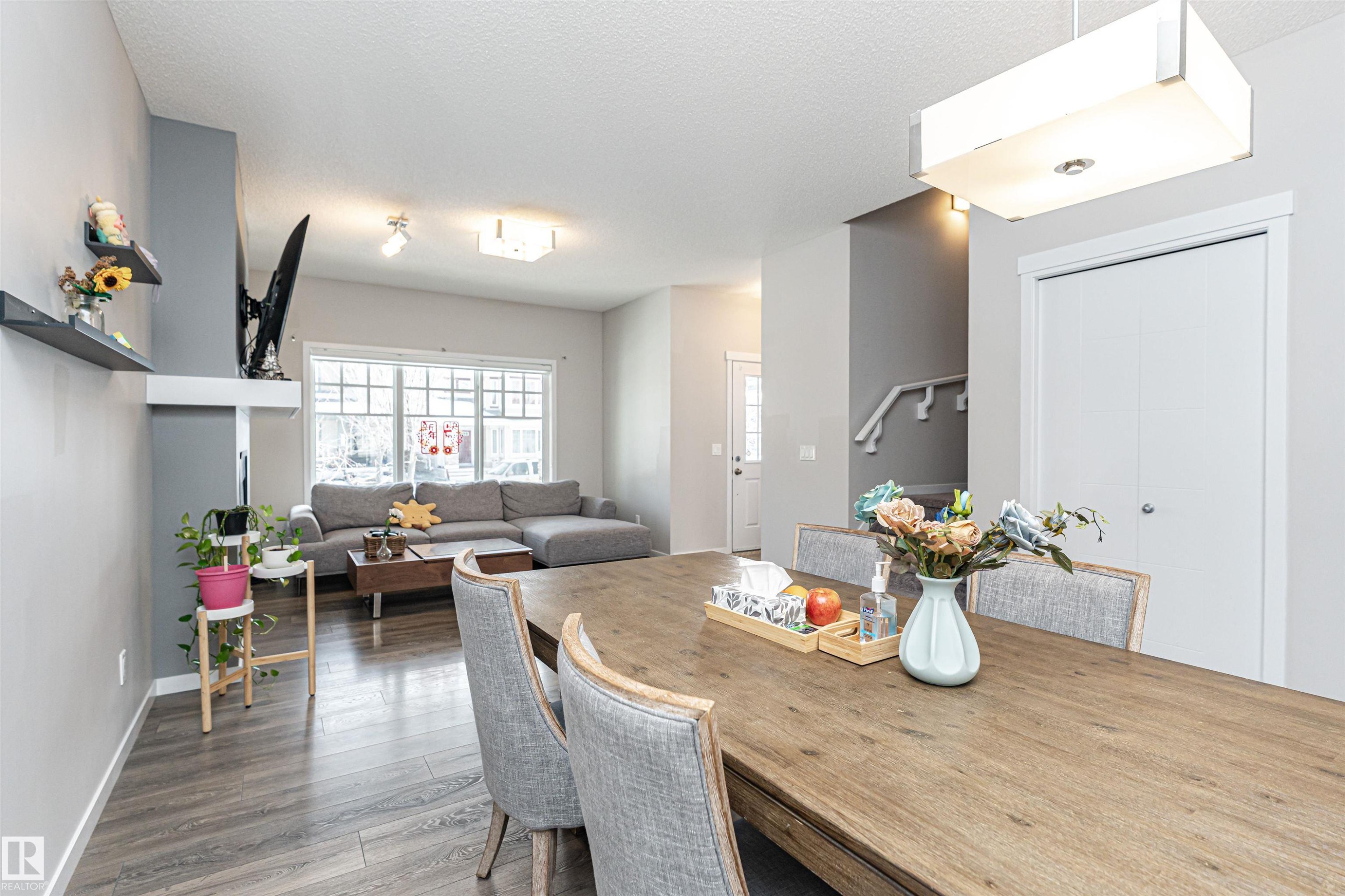 Dining area featuring hardwood / wood-style floors and a textured ceiling - 4008 Allan Crescent, Edmonton, AB - Indoor Photo Showing Dining Room