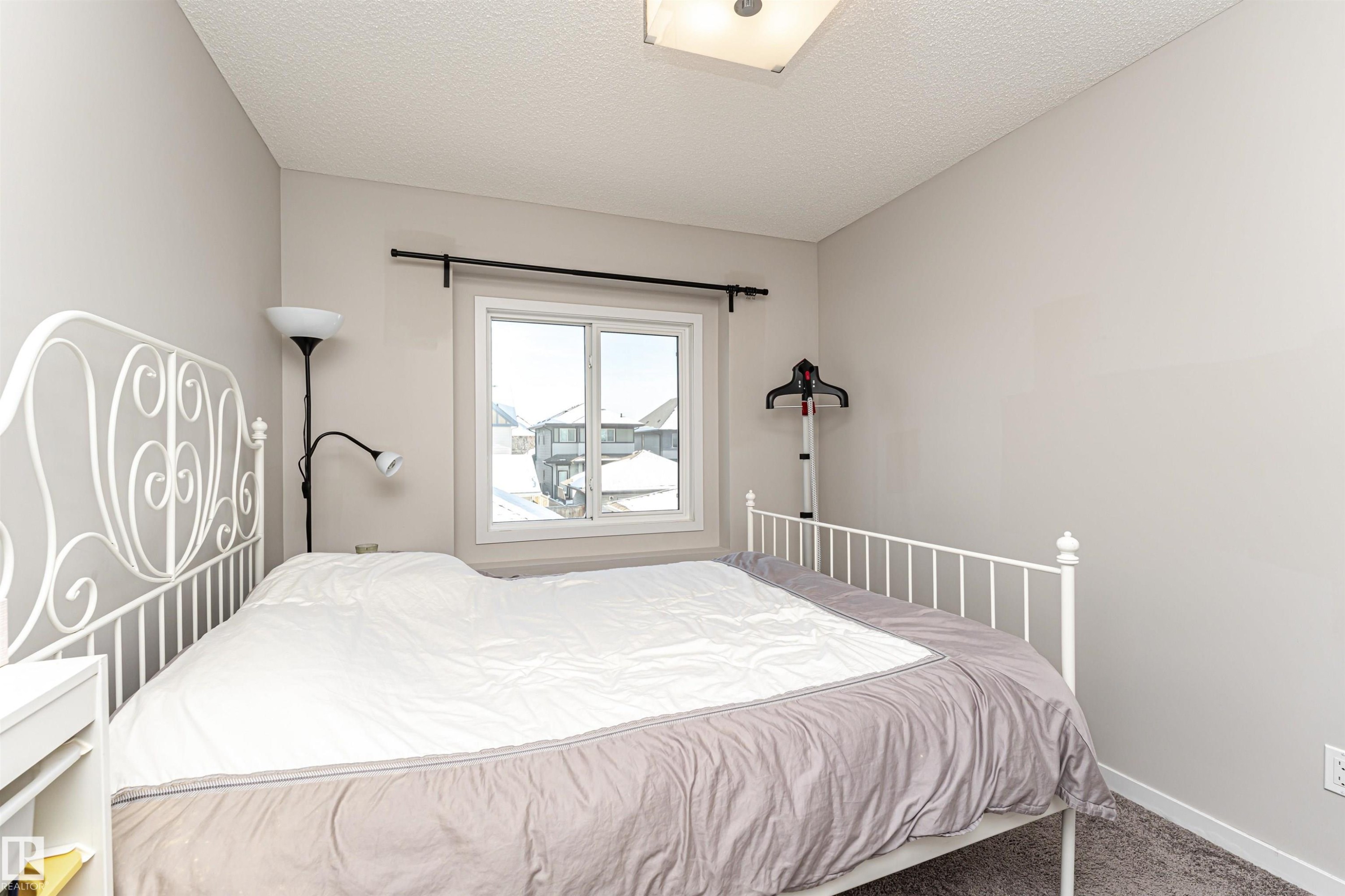 Bedroom with carpet floors and a textured ceiling - 4008 Allan Crescent, Edmonton, AB - Indoor Photo Showing Bedroom