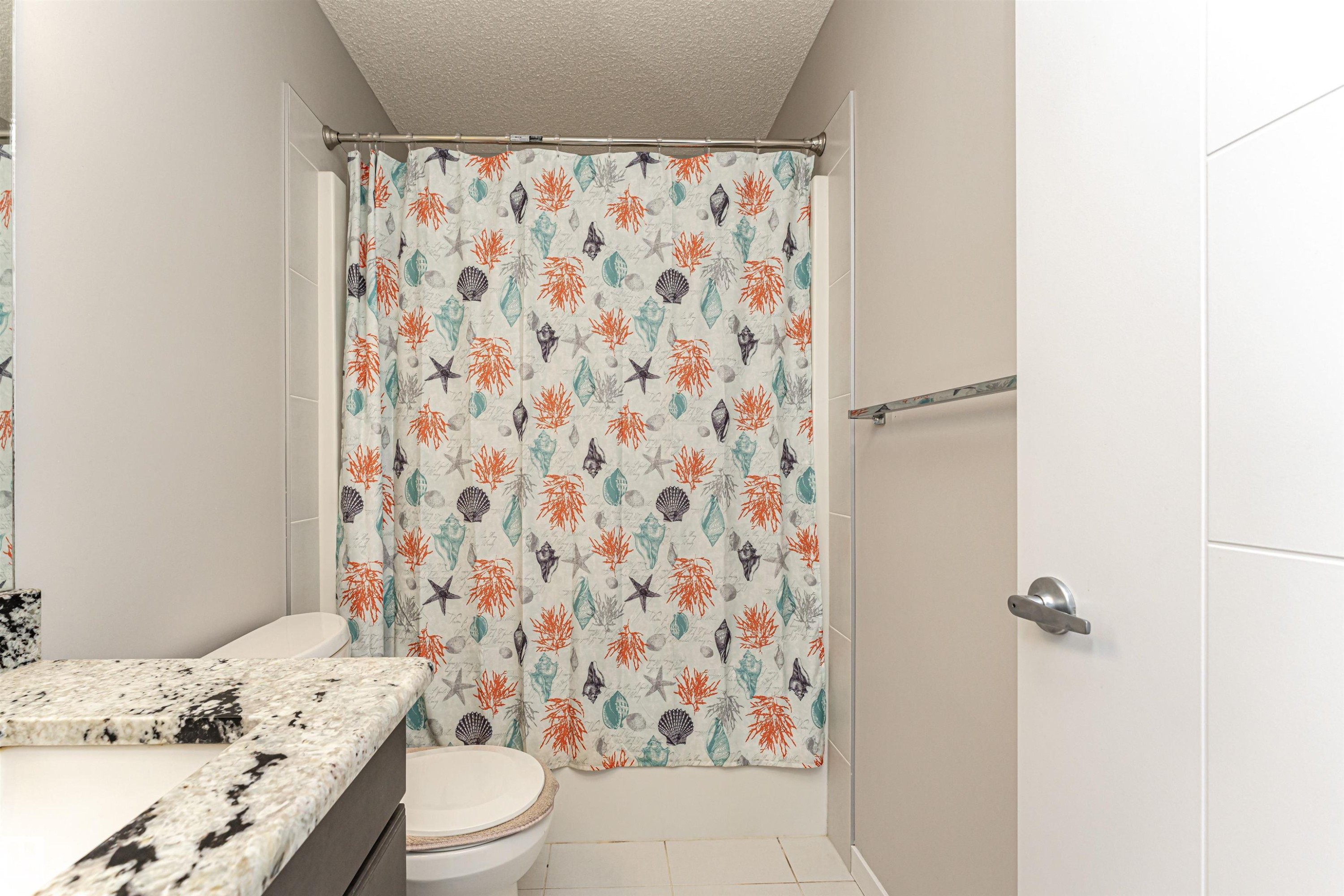 Full bath with vanity, a textured ceiling, light tile patterned floors, and shower / bath combo - 4008 Allan Crescent, Edmonton, AB - Indoor Photo Showing Bathroom