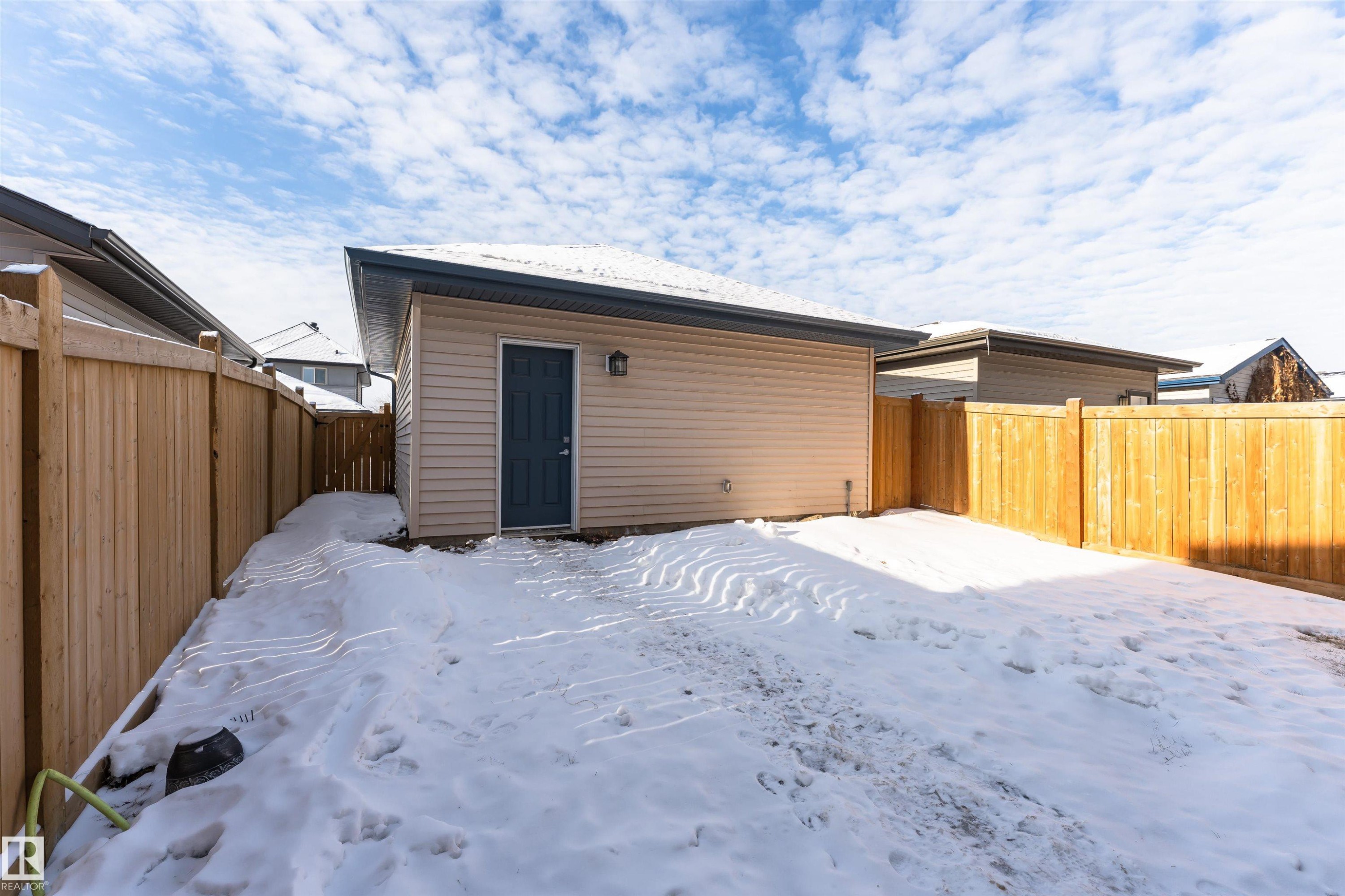 Snow covered rear of property with a fenced backyard - 4008 Allan Crescent, Edmonton, AB - Outdoor With Exterior