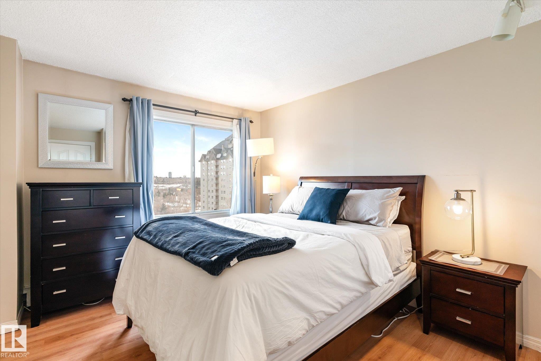Bedroom with light wood-style floors and a textured ceiling - 304 9725 106 Street, Edmonton, AB - Indoor Photo Showing Bedroom