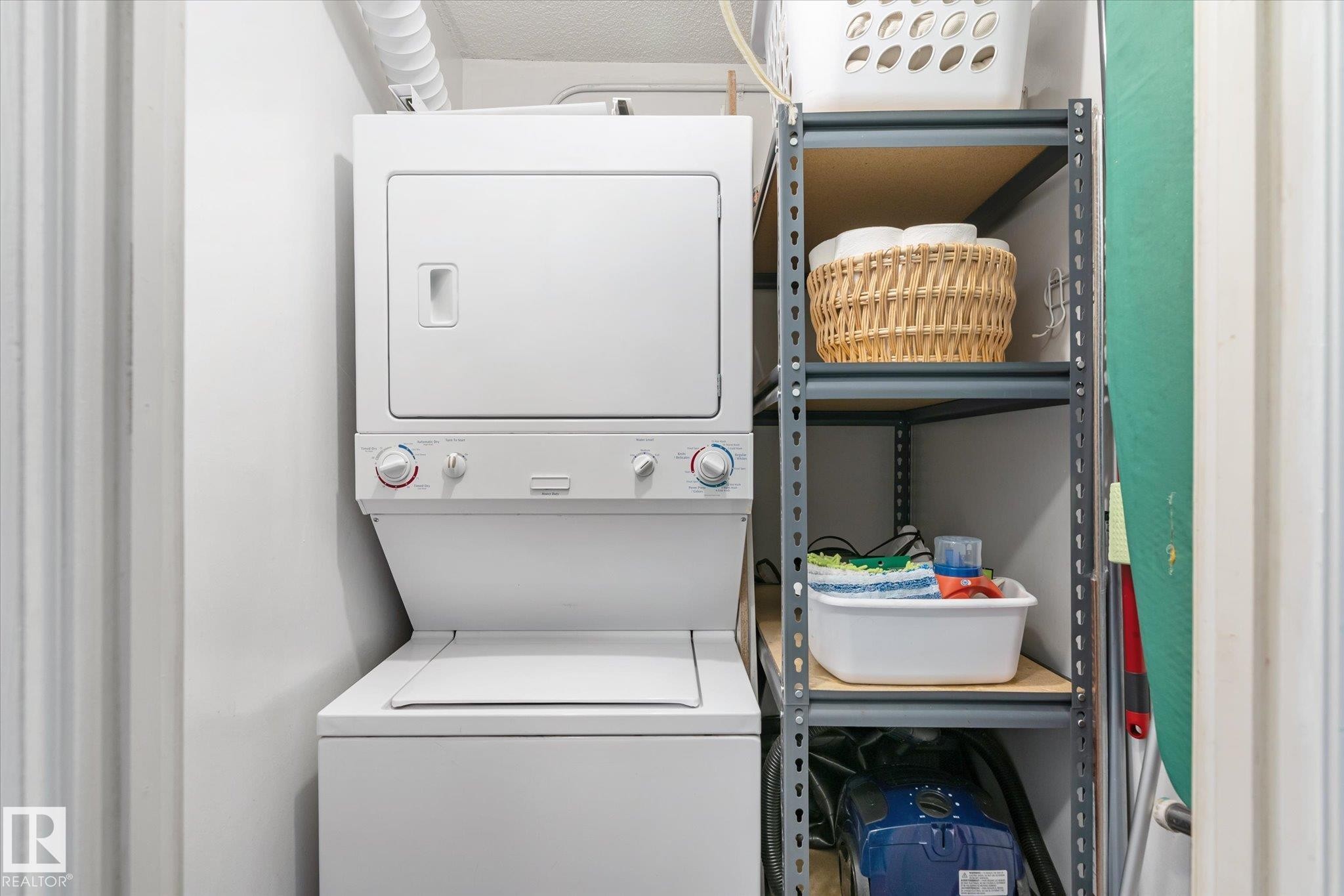 Laundry area with stacked washer and dryer - 304 9725 106 Street, Edmonton, AB - Indoor Photo Showing Laundry Room