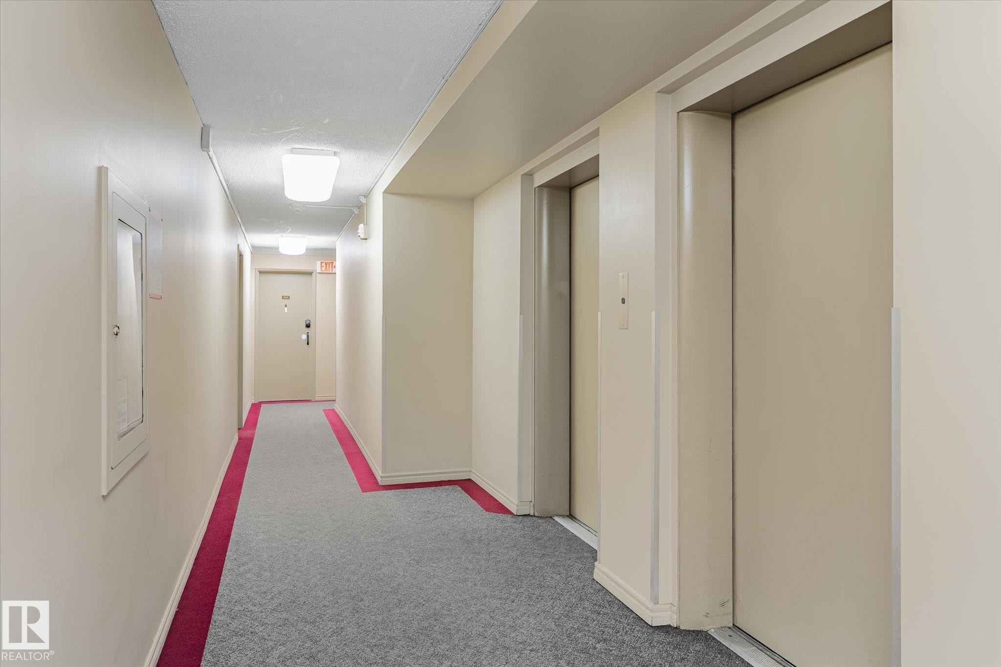 Corridor featuring elevator and carpet - 304 9725 106 Street, Edmonton, AB - Indoor Photo Showing Other Room