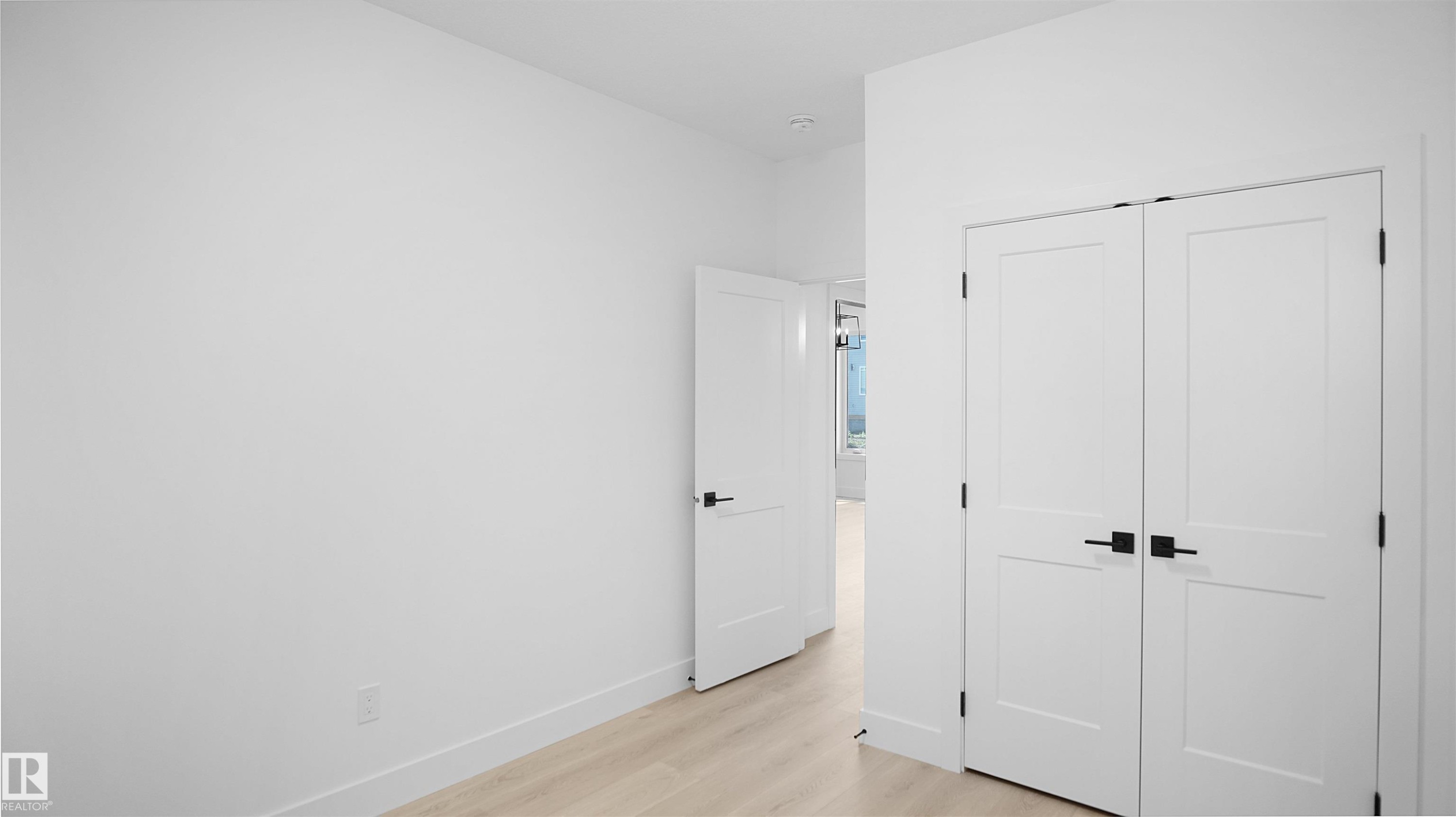 Unfurnished bedroom featuring light wood-type flooring and a closet - 711 31 Avenue, Edmonton, AB - Indoor Photo Showing Other Room