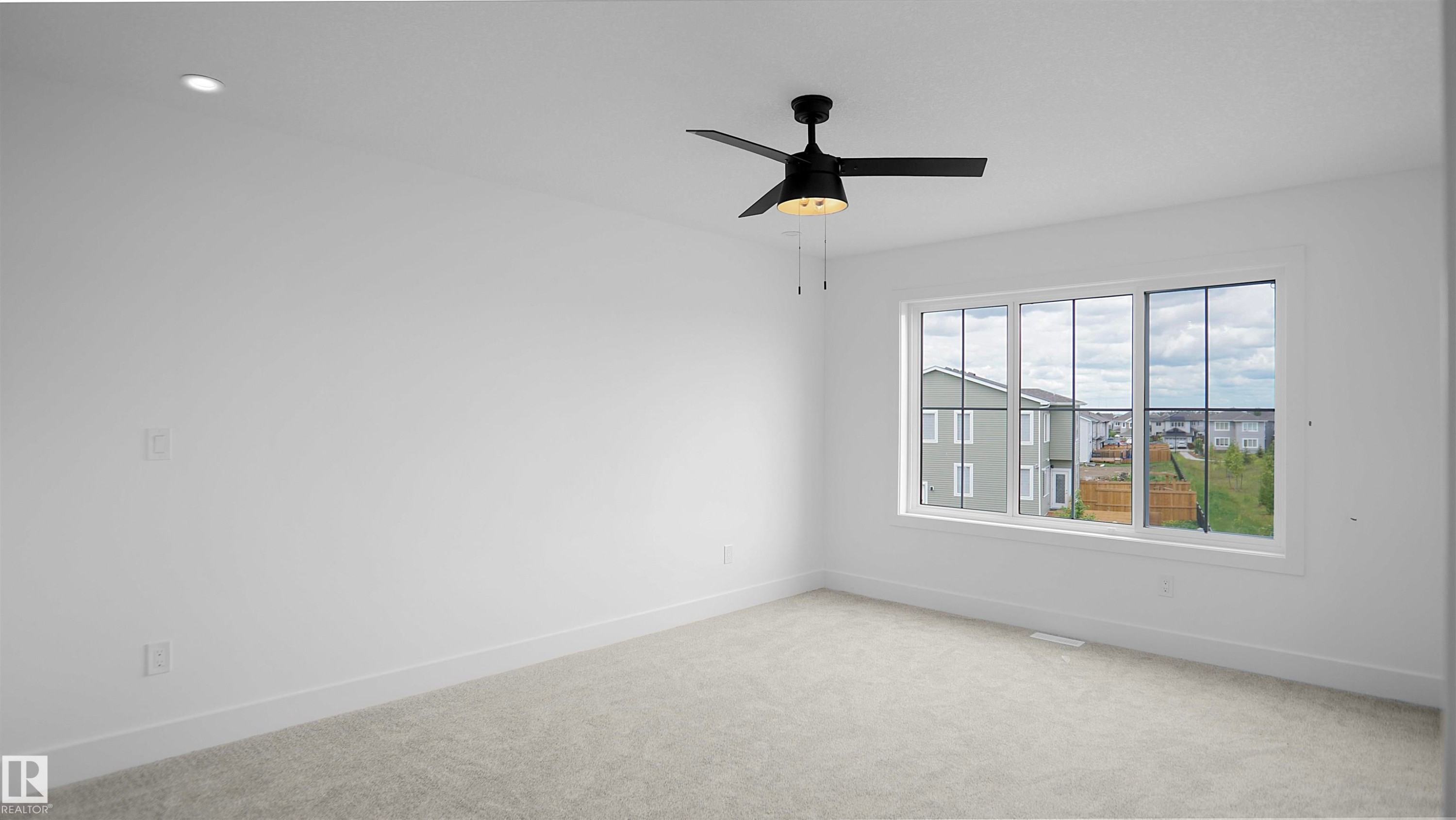 Carpeted empty room with baseboards and a ceiling fan - 711 31 Avenue, Edmonton, AB - Indoor Photo Showing Other Room