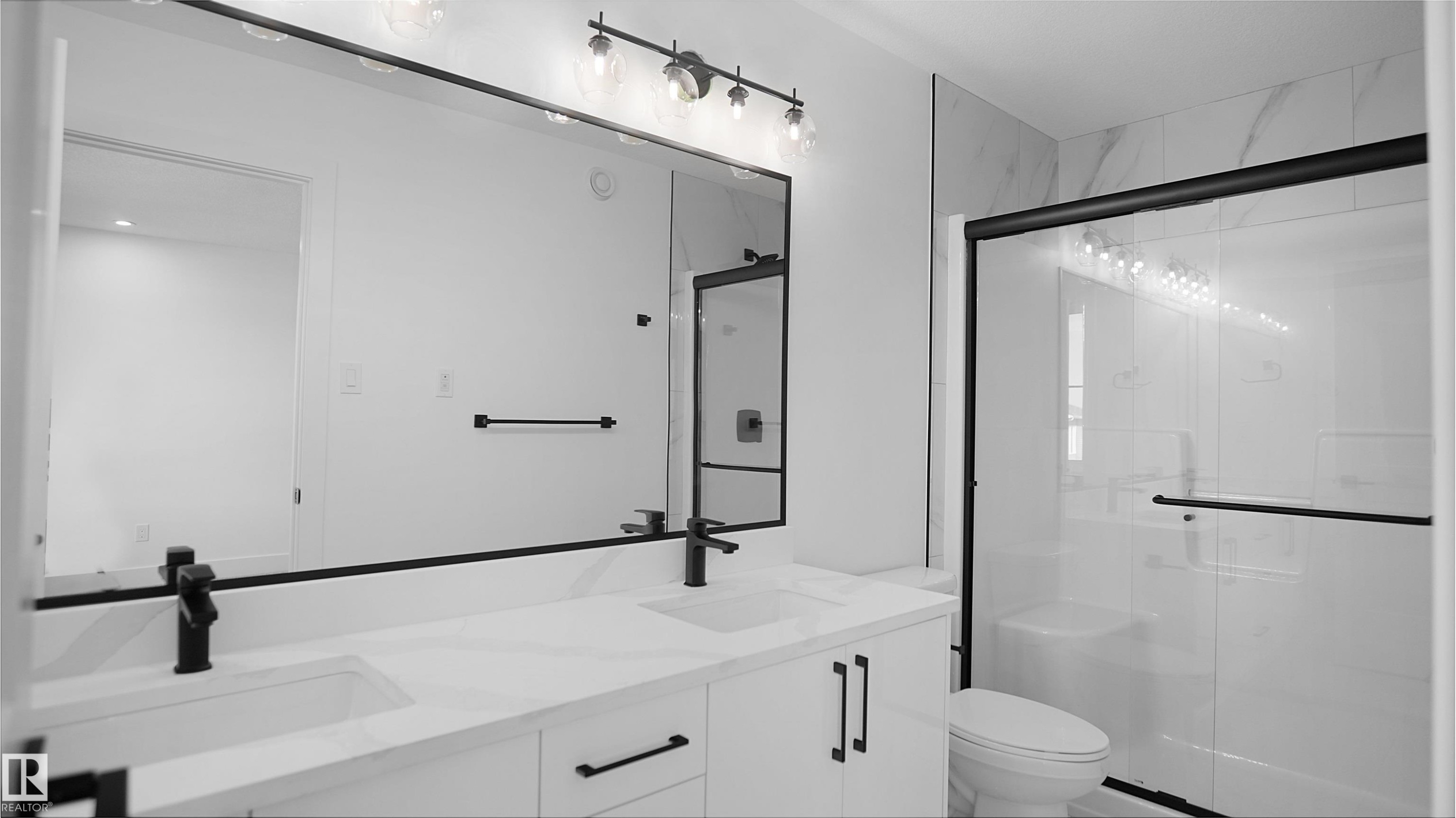 Full bath featuring a stall shower and double vanity - 711 31 Avenue, Edmonton, AB - Indoor Photo Showing Bathroom