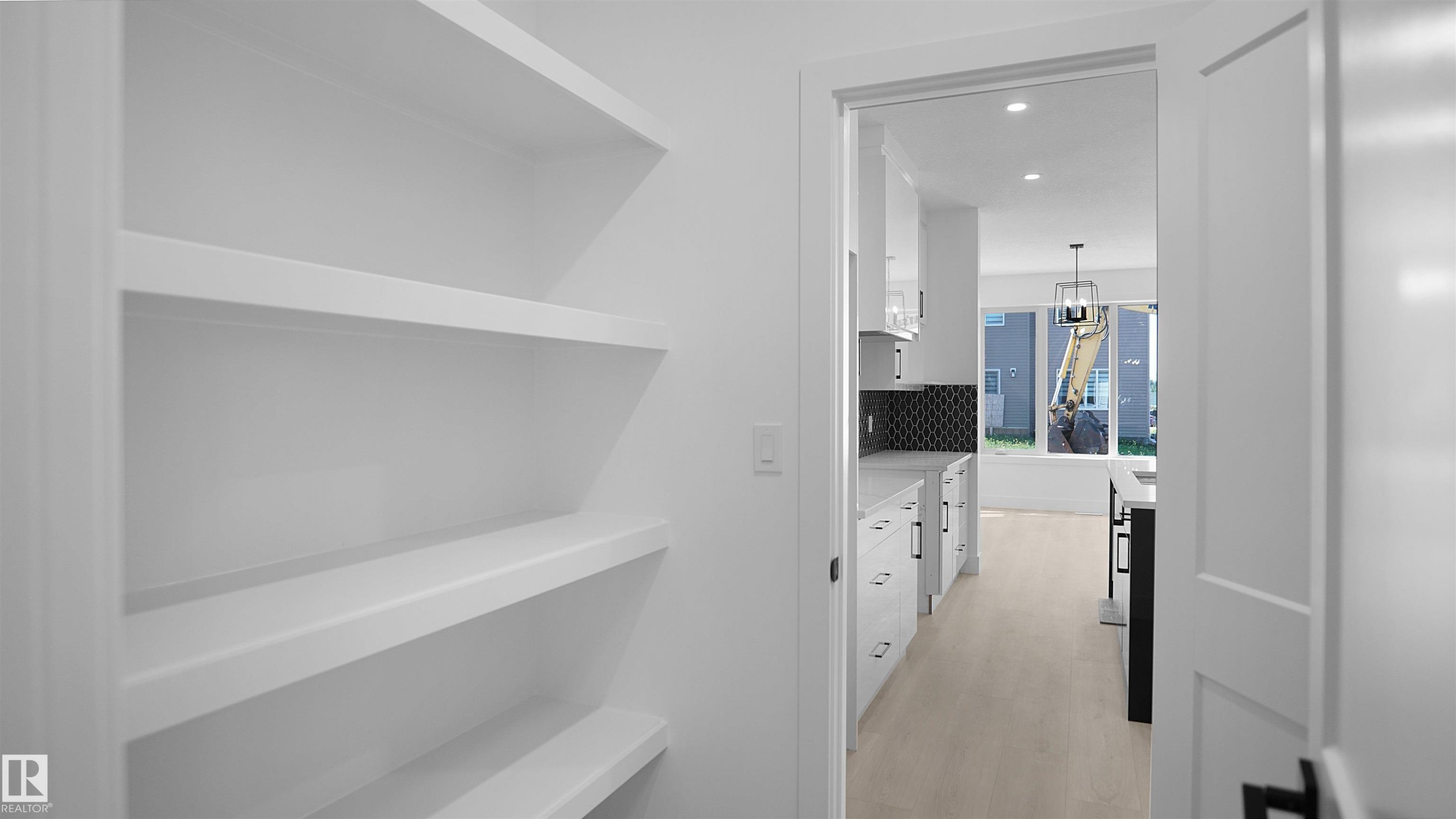 Hallway with recessed lighting and light wood finished floors - 711 31 Avenue, Edmonton, AB - Indoor