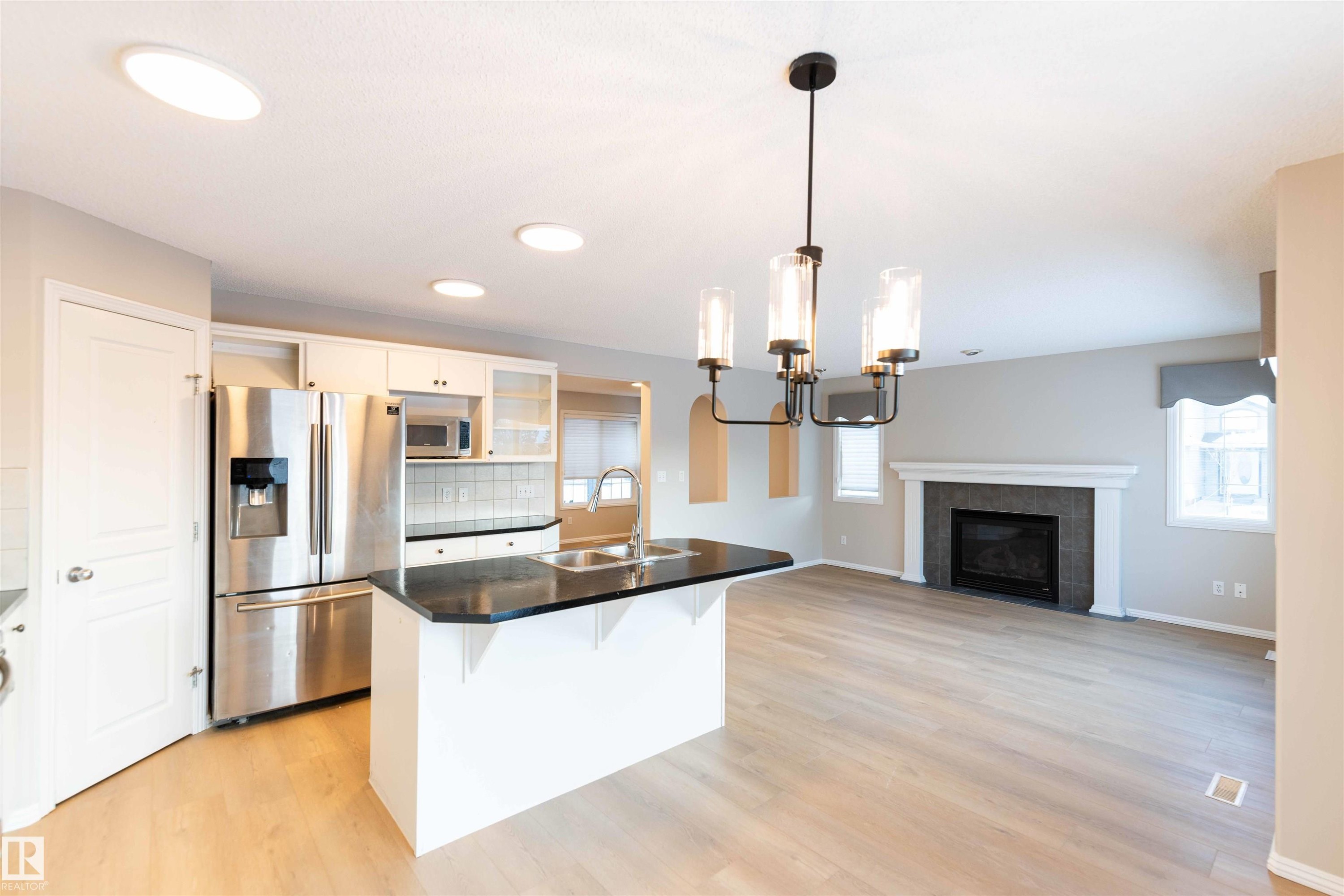 11211 11 Ave, Edmonton, AB - Indoor Photo Showing Kitchen With Fireplace With Double Sink