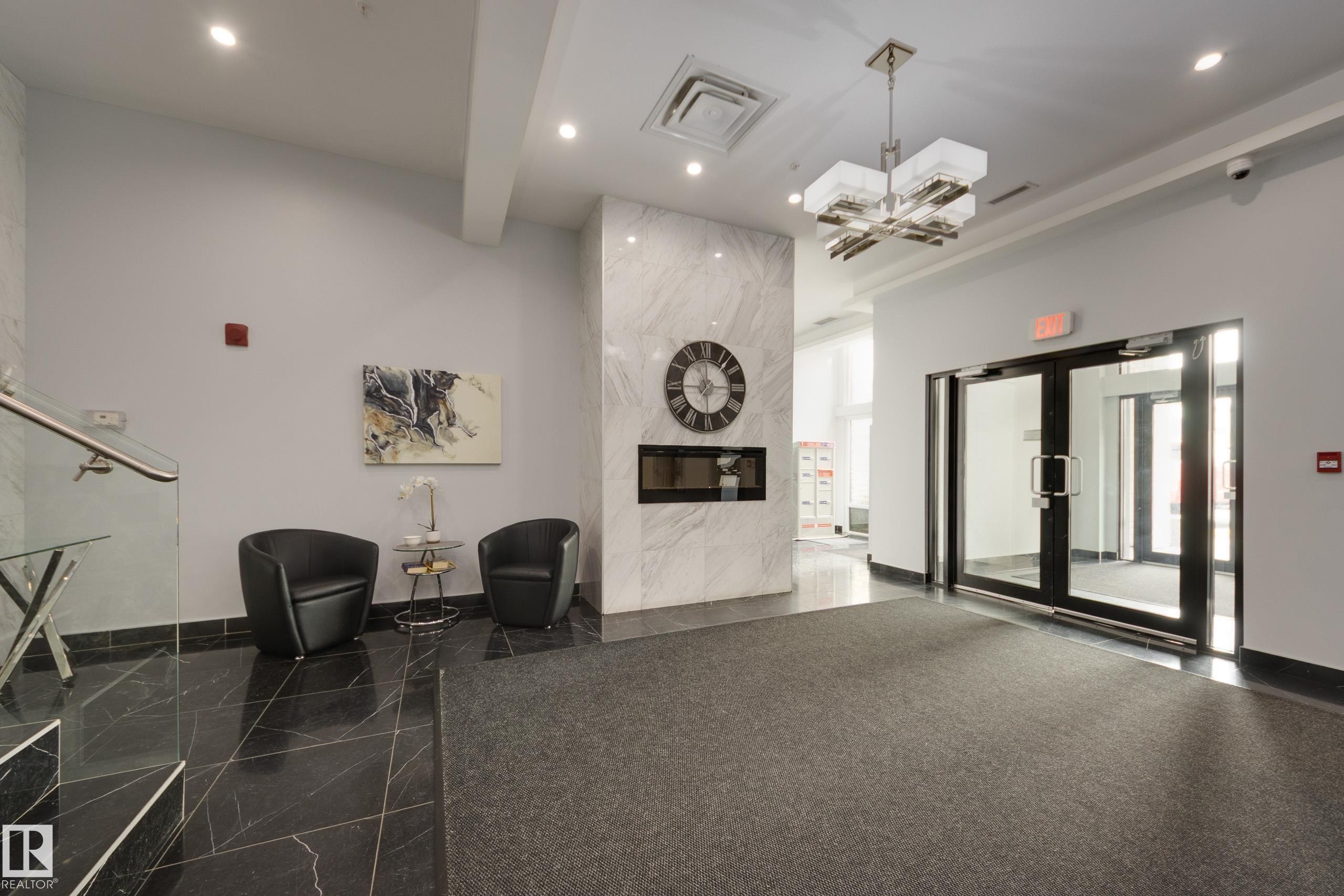 403 1350 Windermere Way, Edmonton, AB - Indoor Photo Showing Other Room With Fireplace