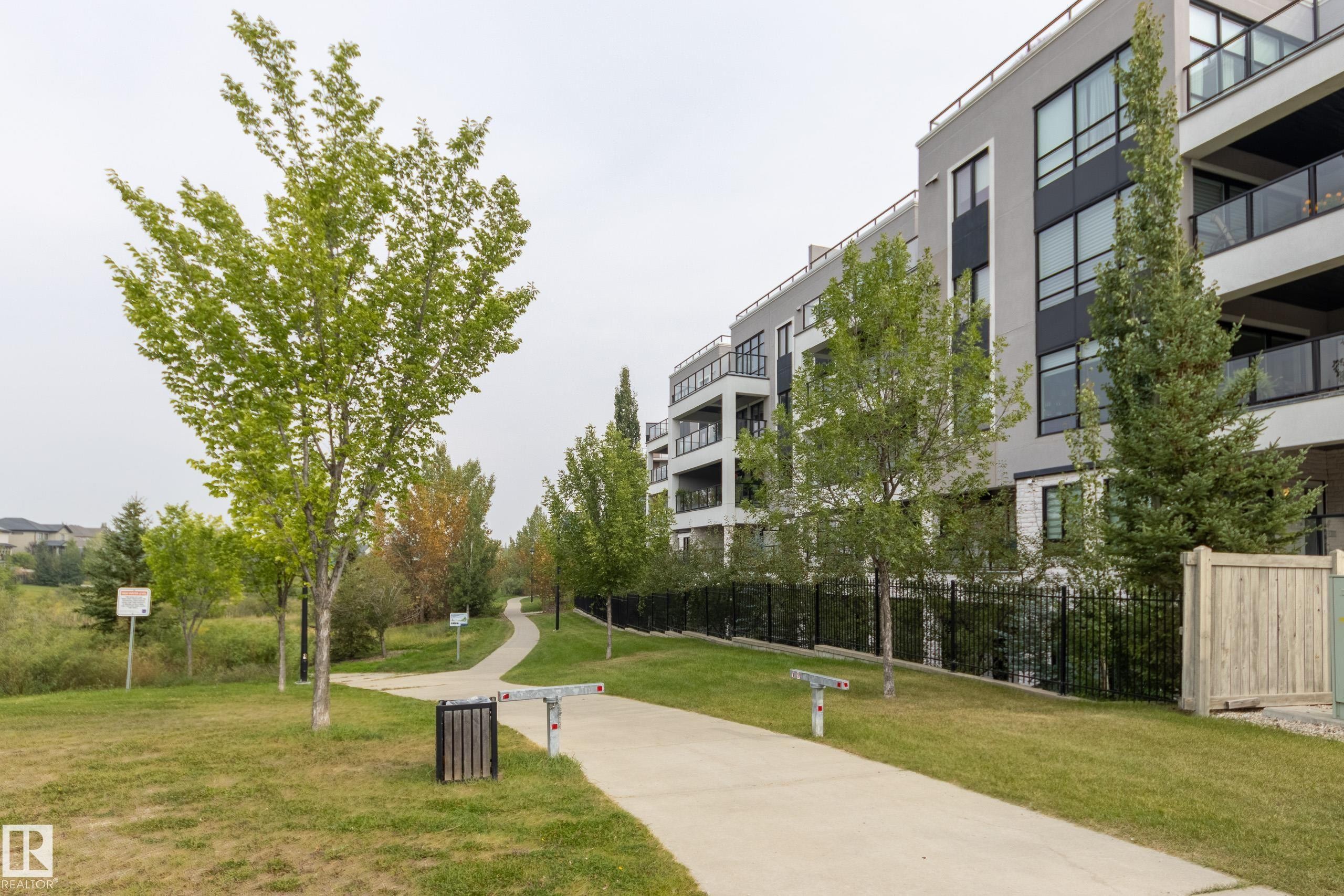 View of home's community with a lawn - 403 1350 Windermere Way, Edmonton, AB - Outdoor With Balcony