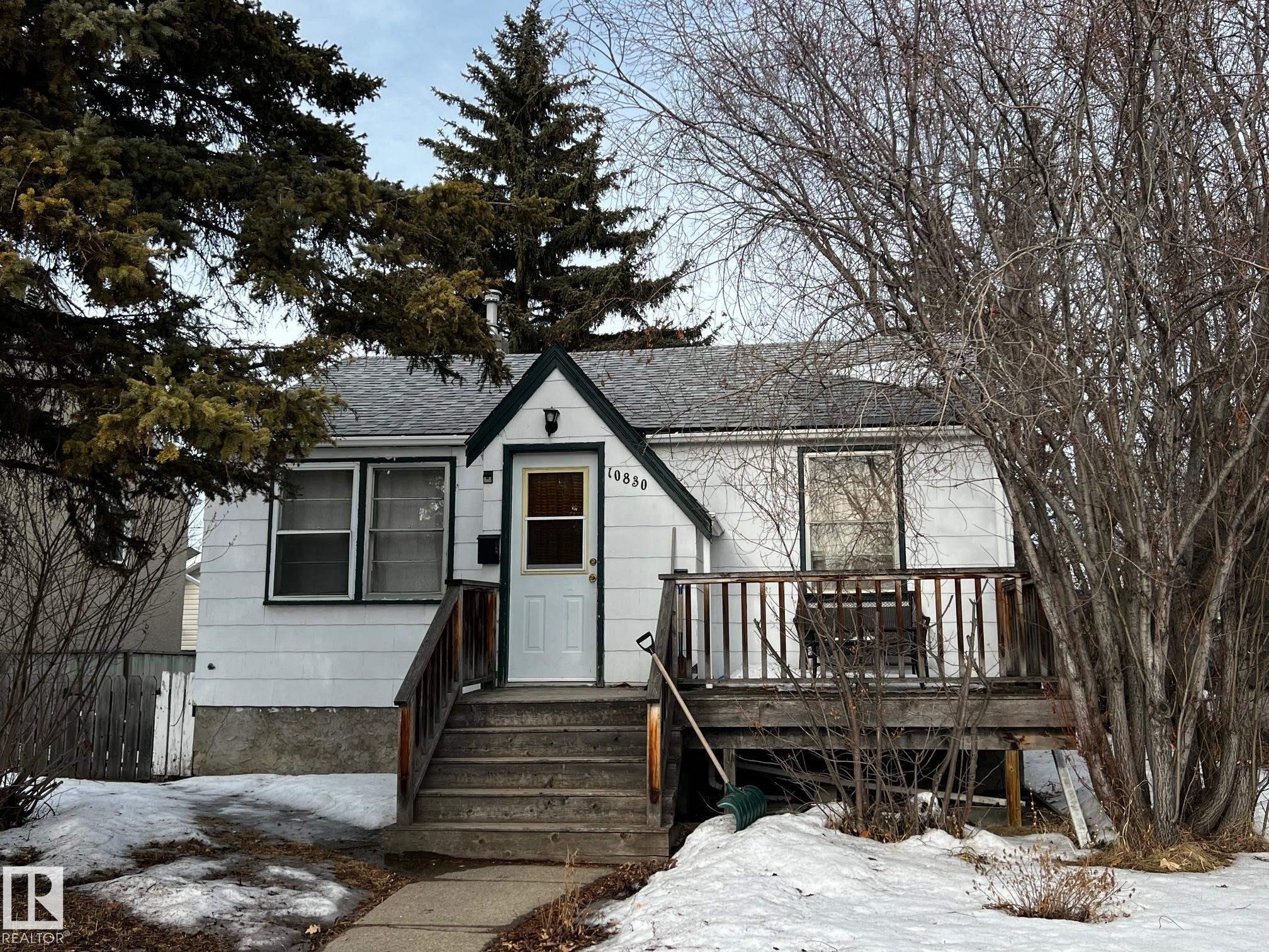 View of front of home featuring roof with shingles and a wooden deck - 10830 68 Avenue, Edmonton, AB - Outdoor