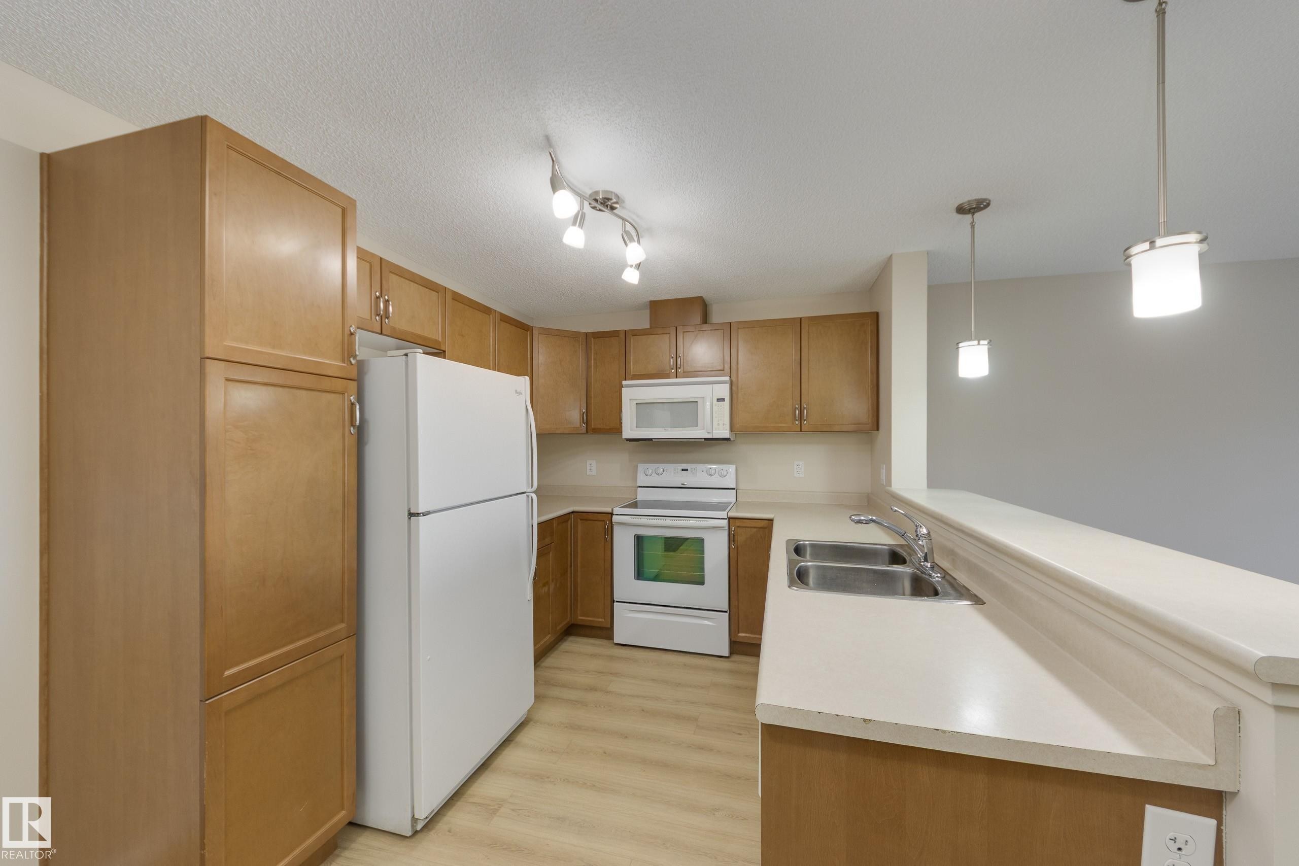 404 6070 Schonsee Way, Edmonton, AB - Indoor Photo Showing Kitchen With Double Sink