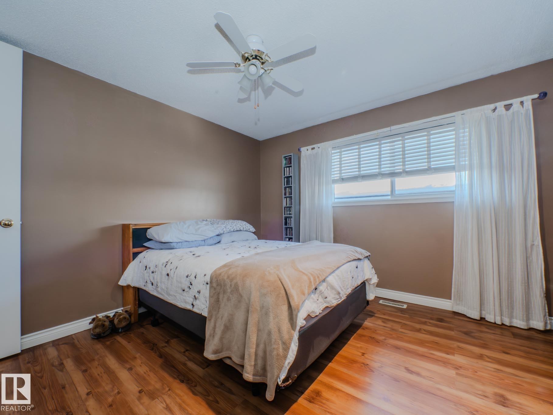 Bedroom with wood finished floors and a ceiling fan - 3204 113B Street, Edmonton, AB - Indoor Photo Showing Bedroom