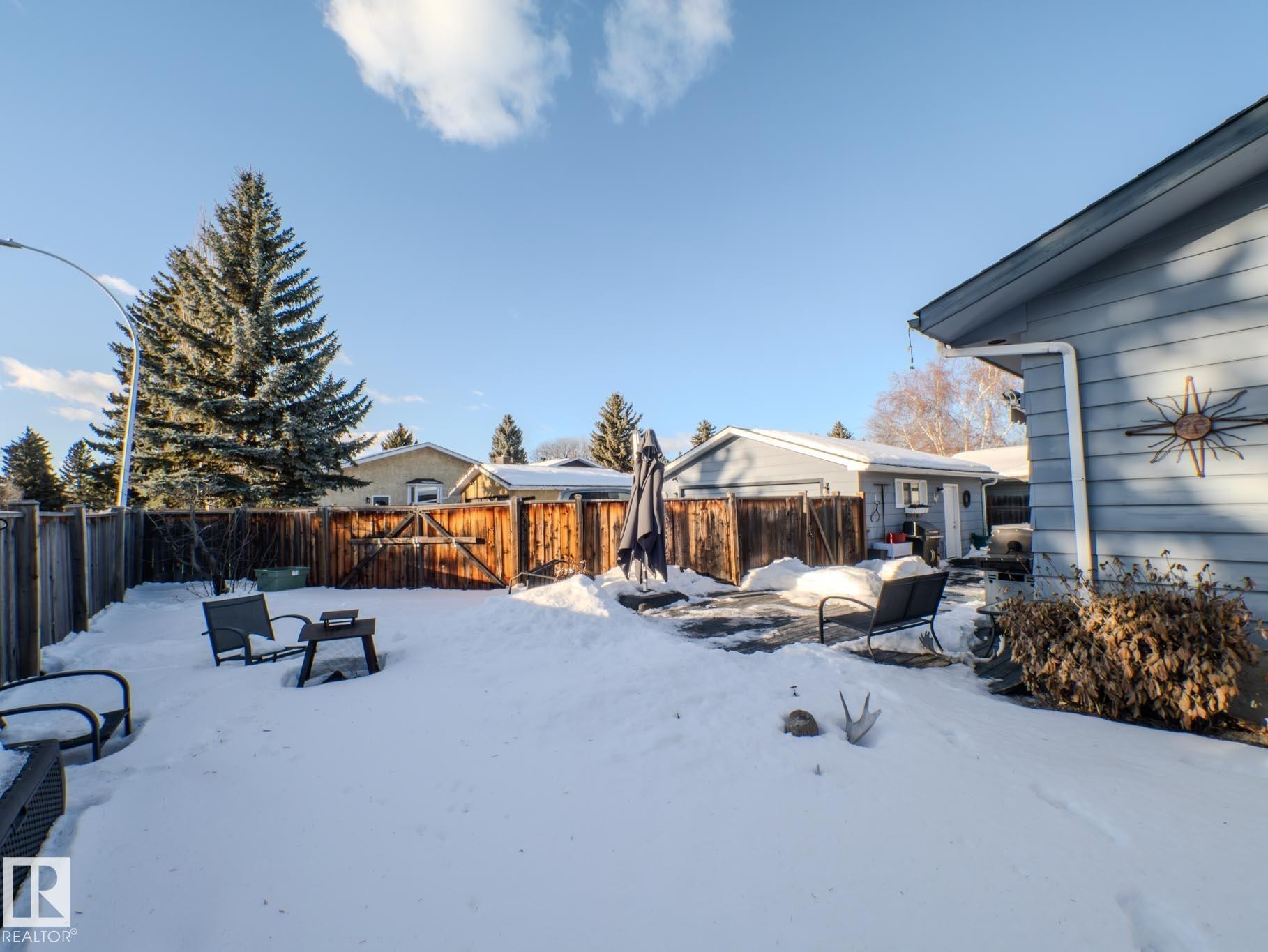 Snowy yard with a fenced backyard and a patio area - 3204 113B Street, Edmonton, AB - Outdoor