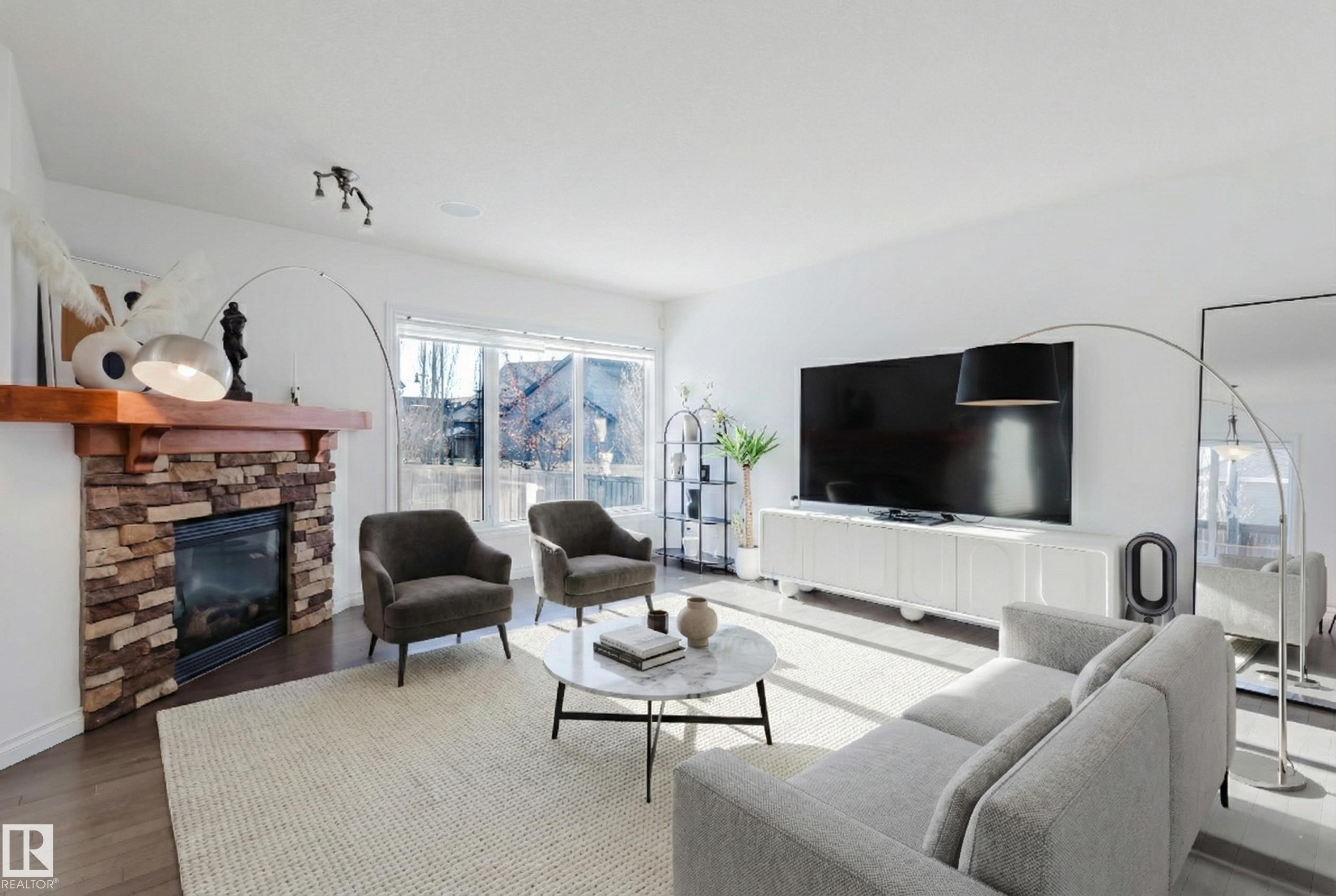 Living area with wood finished floors and a fireplace - 3547 Mclay Crescent, Edmonton, AB - Indoor Photo Showing Living Room With Fireplace