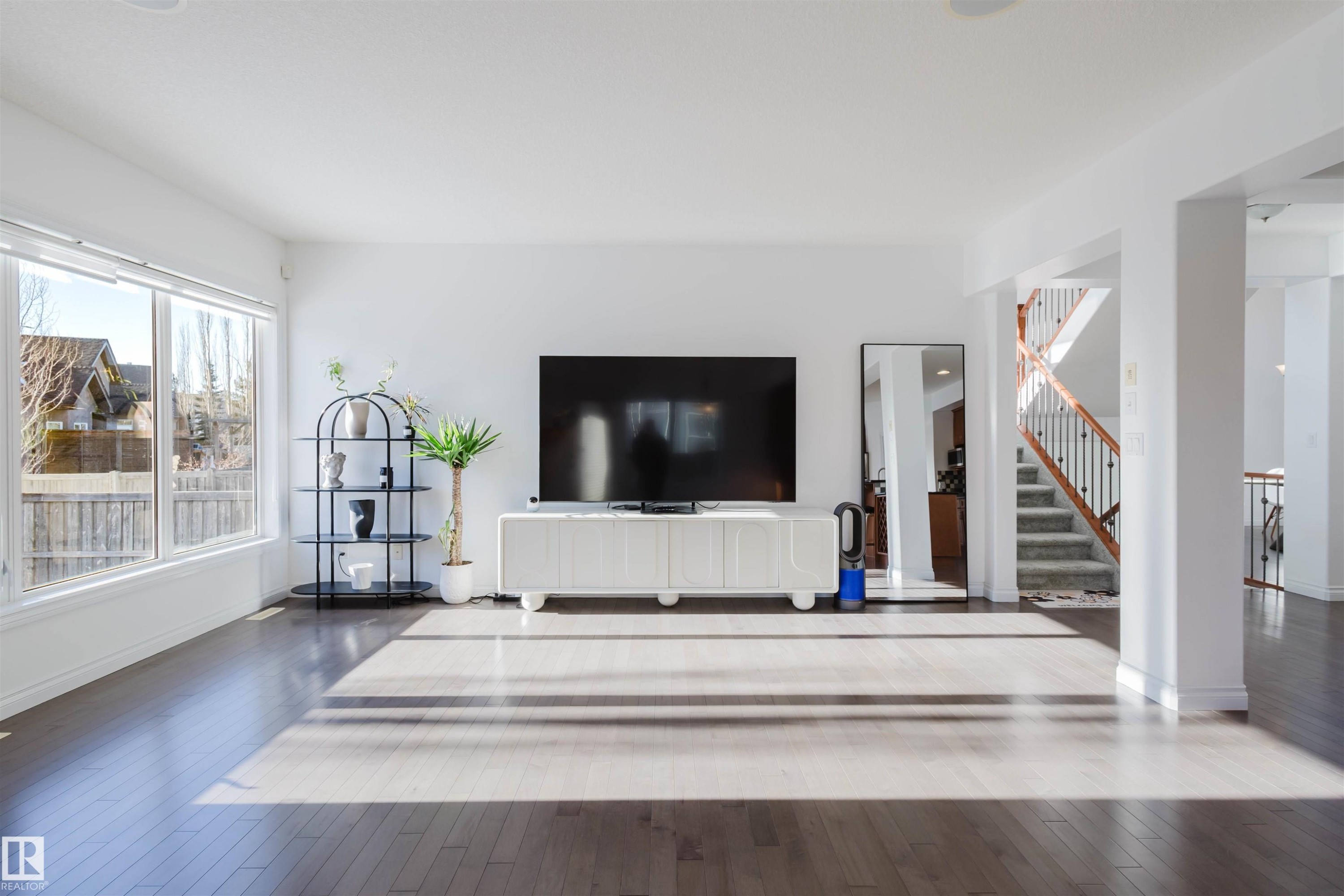 Unfurnished living room featuring stairway and hardwood / wood-style flooring - 3547 Mclay Crescent, Edmonton, AB - Indoor Photo Showing Other Room