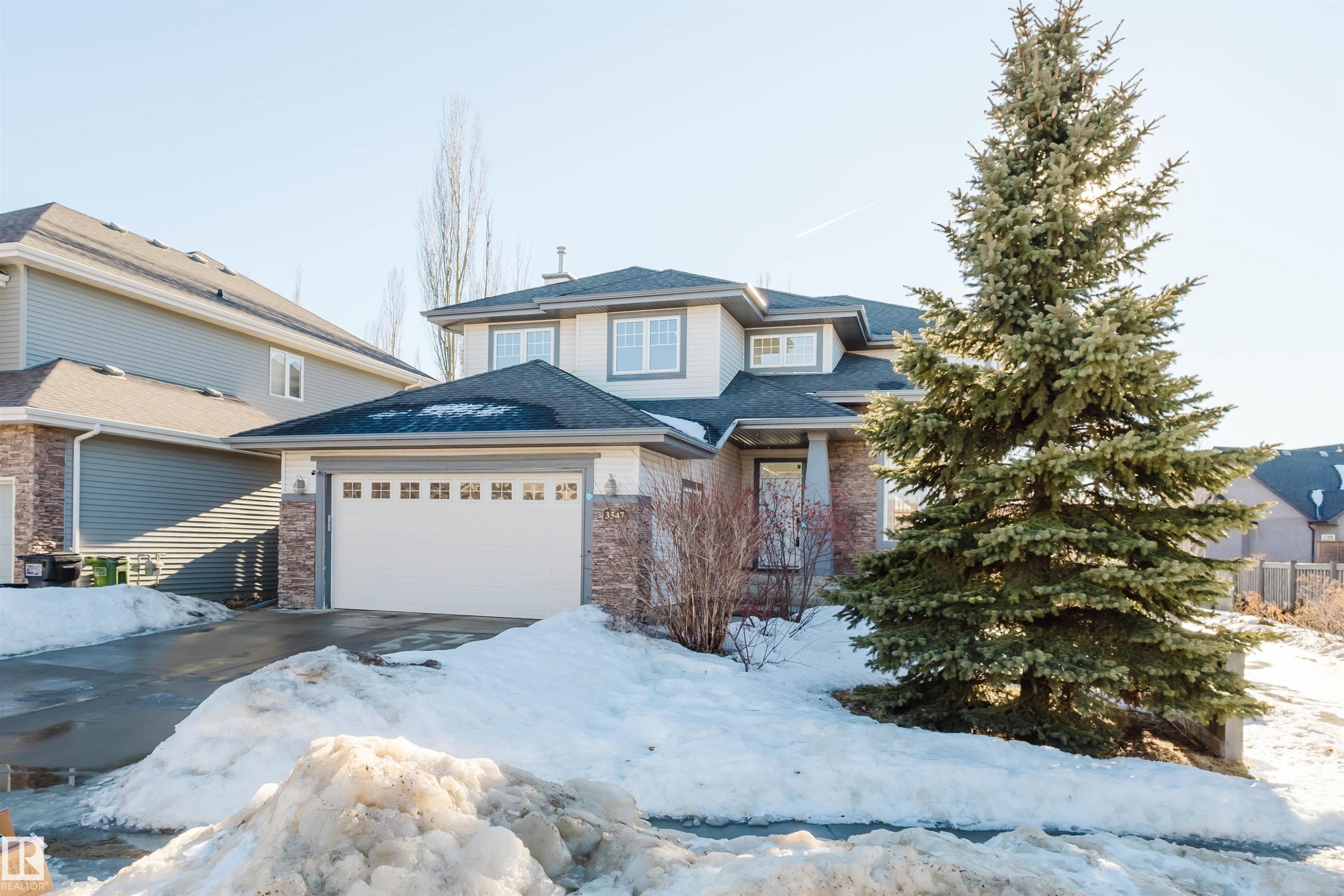 View of front of home with a shingled roof, a garage, and driveway - 3547 Mclay Crescent, Edmonton, AB - Outdoor