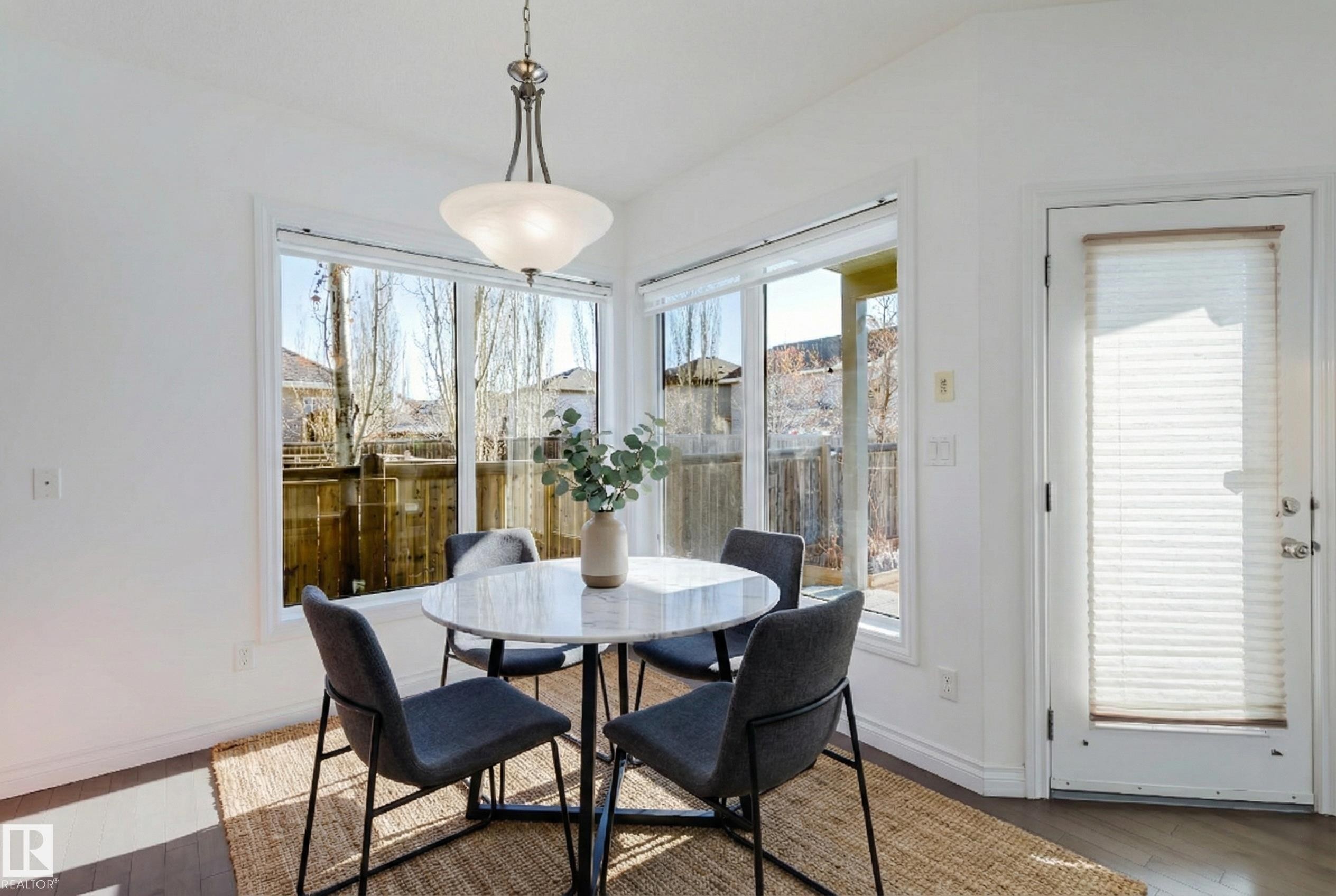 Dining area with wood finished floors and baseboards - 3547 Mclay Crescent, Edmonton, AB - Indoor Photo Showing Dining Room